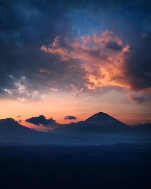 Sunset Behind a Volcanic Mountain with Dramatic Clouds
