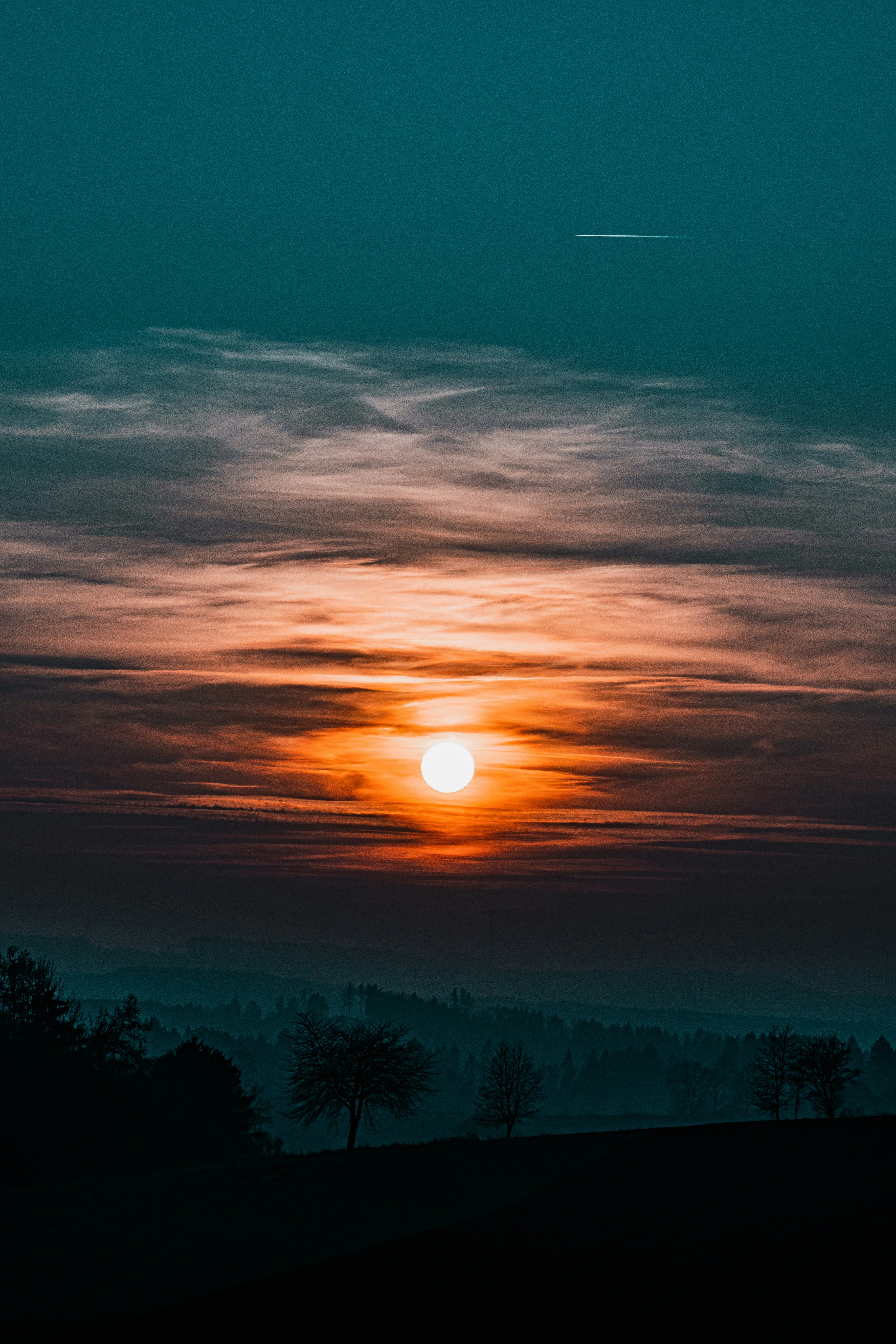 Sunset Casting Orange Glow Beneath Cloudy Sky Wallpaper