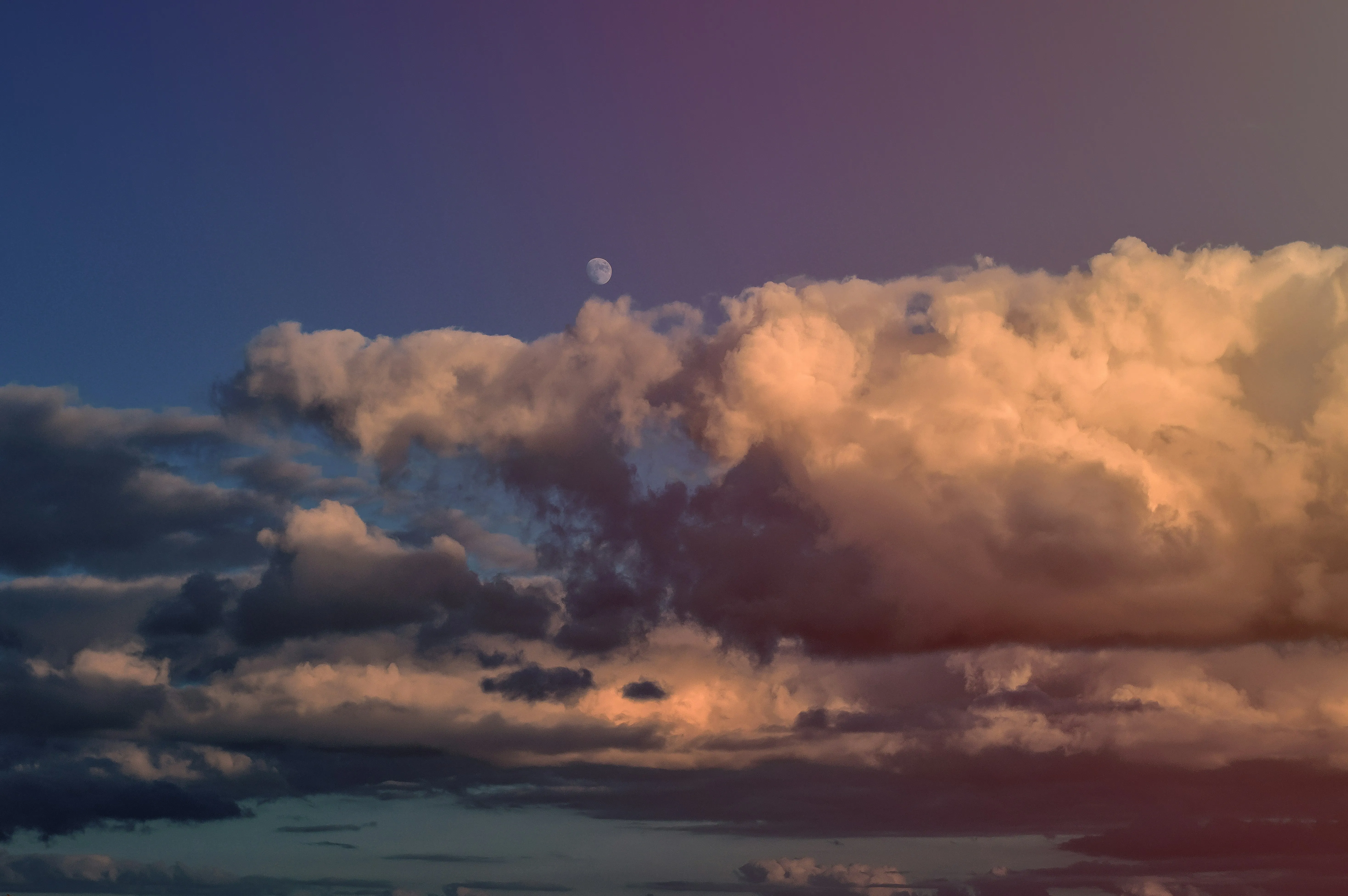 Sunset Clouds with Deep Orange Glow Over Horizon Image