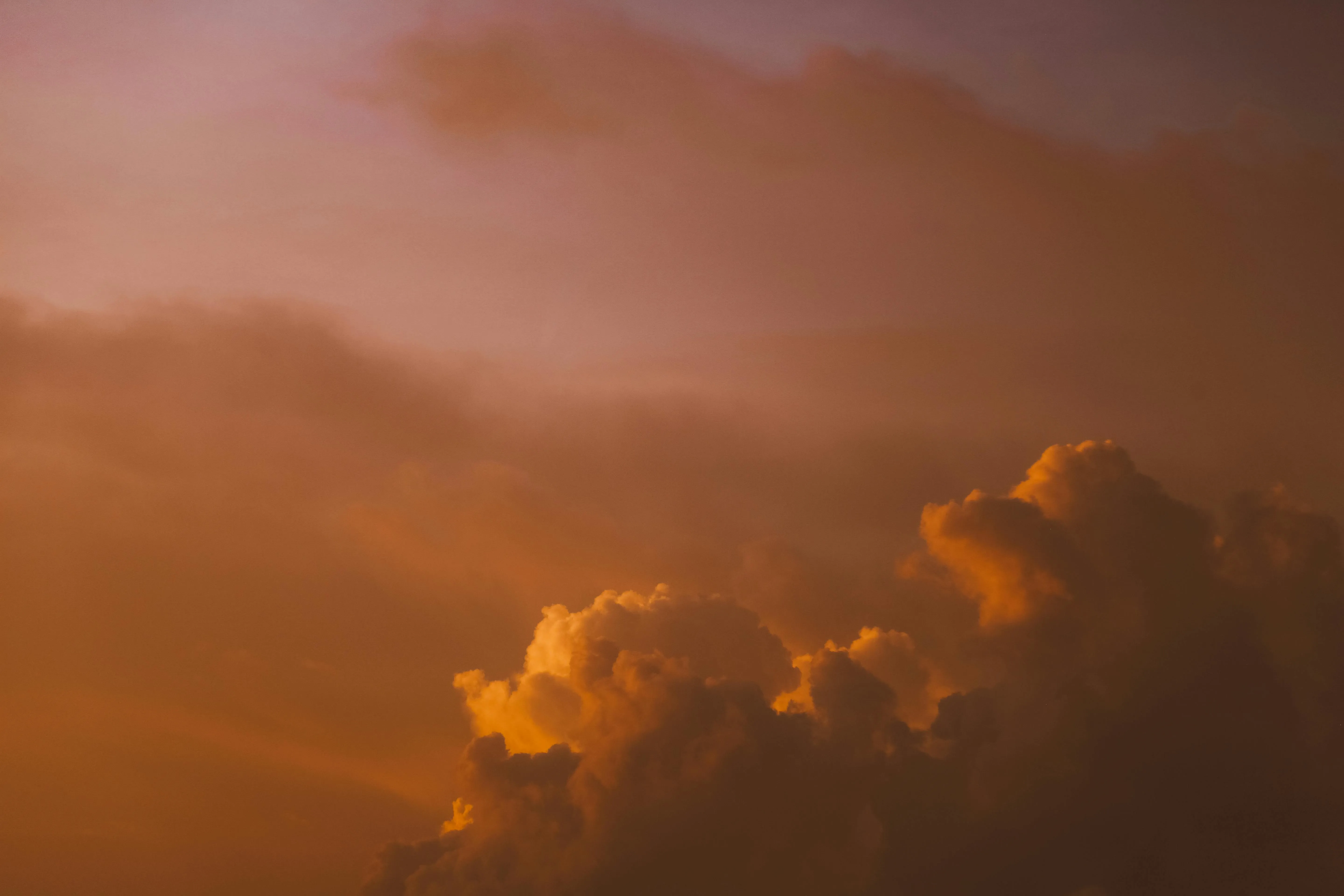 Sunset Light Glowing Through Orange Storm Clouds Wallpaper
