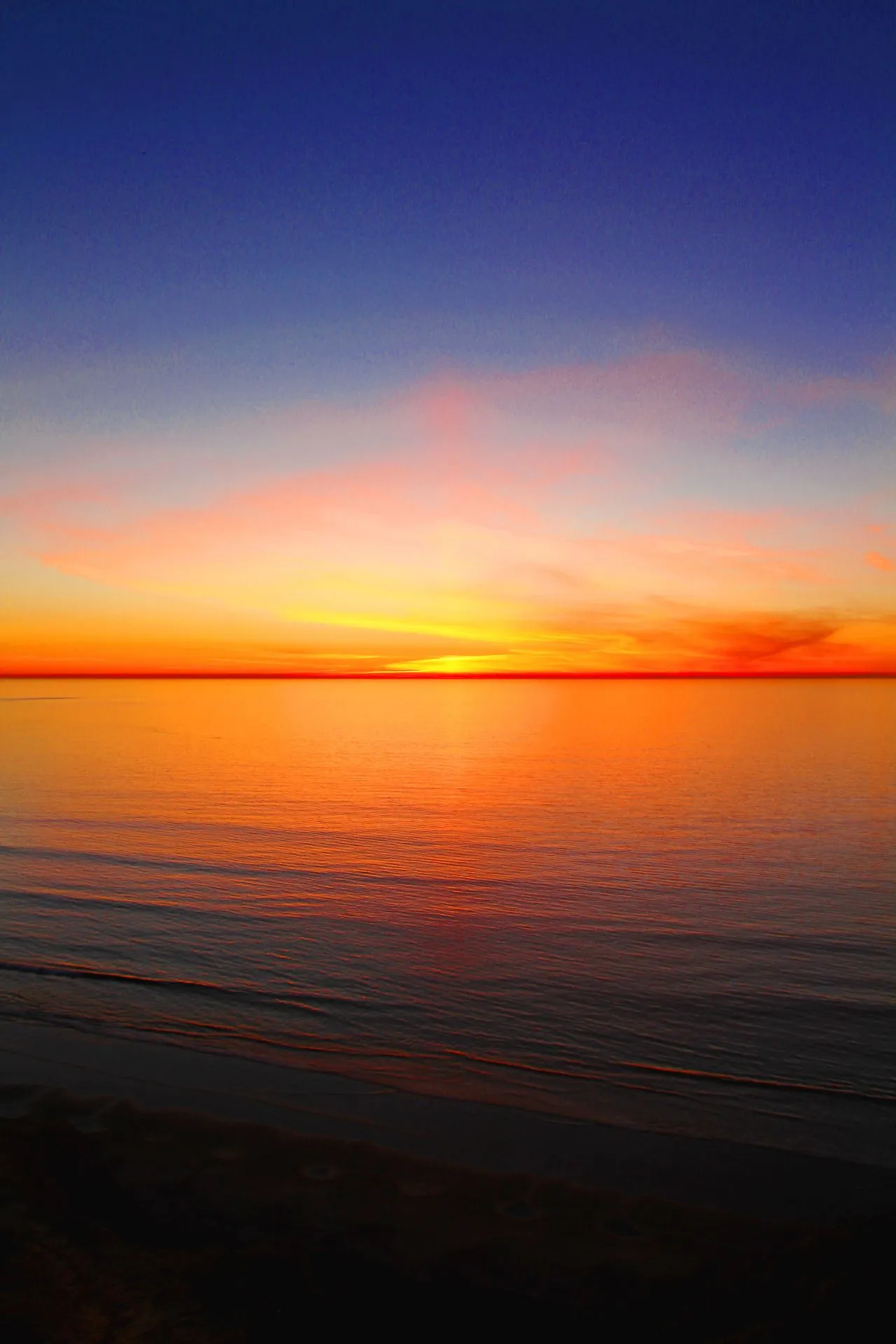 Sunset Over Calm Ocean with Orange and Purple Hues HD