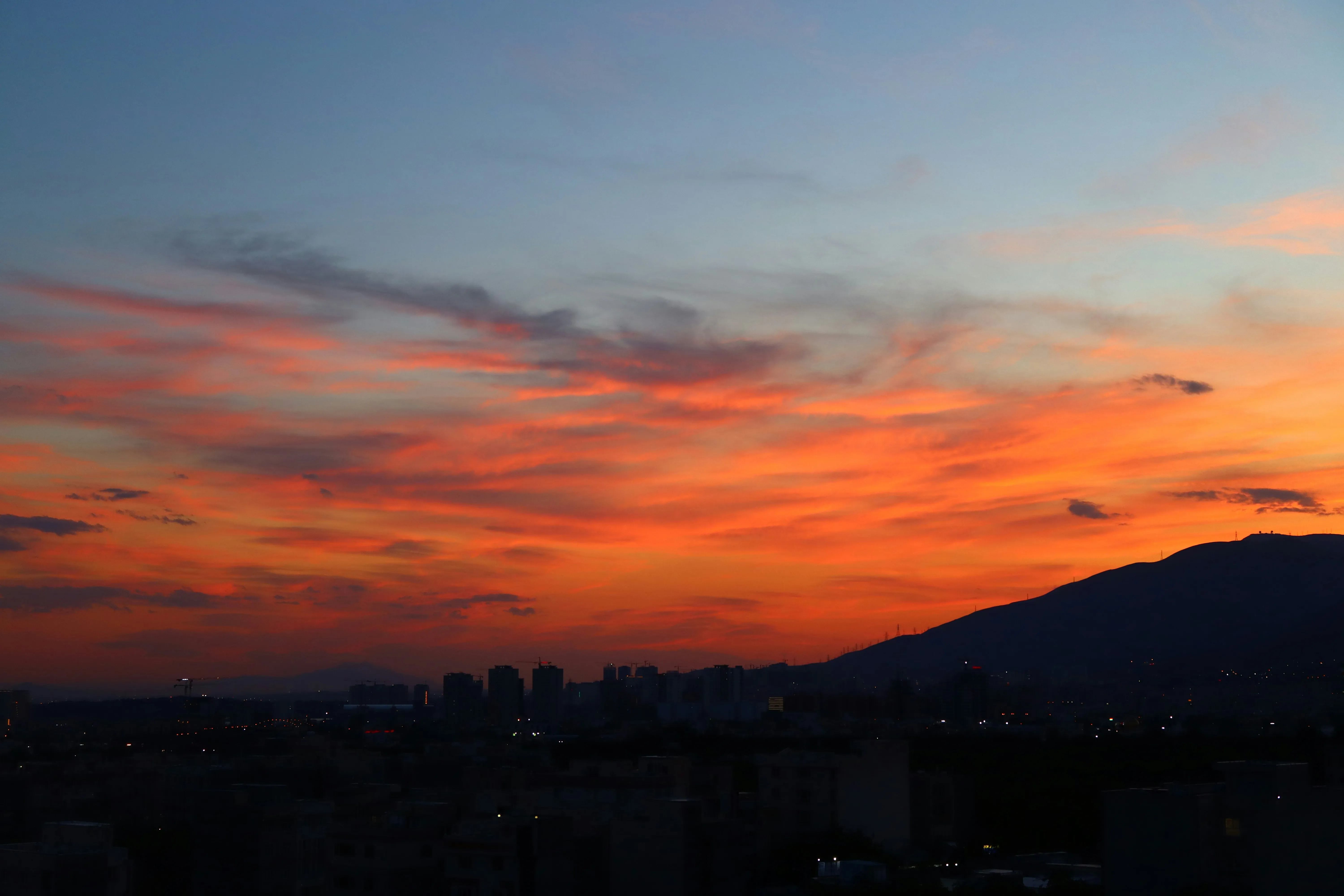 Sunset Sky Glowing Orange Behind Mountain Silhouette
