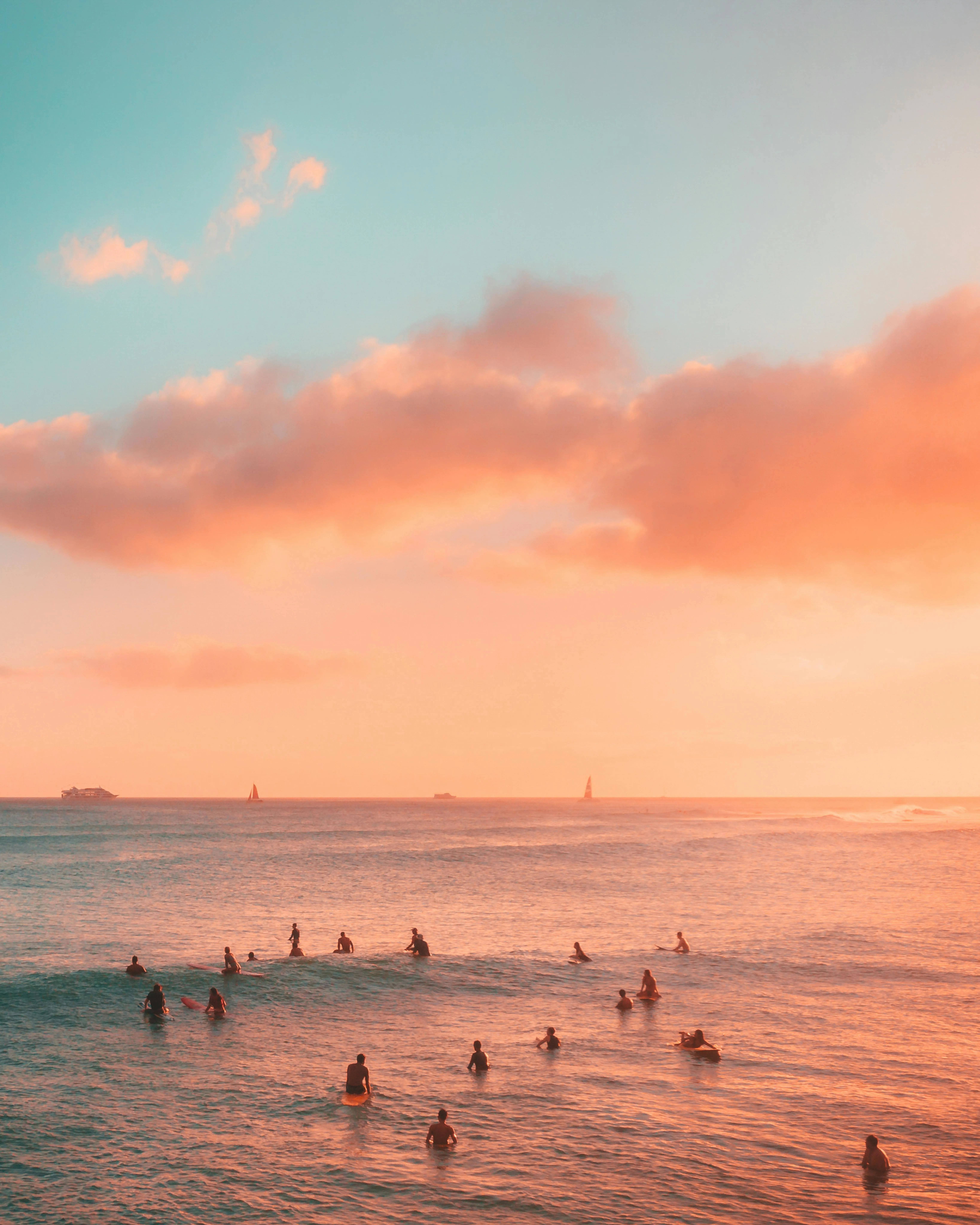 Surfers Enjoying Sunset Surfing with Vibrant Sky Colors