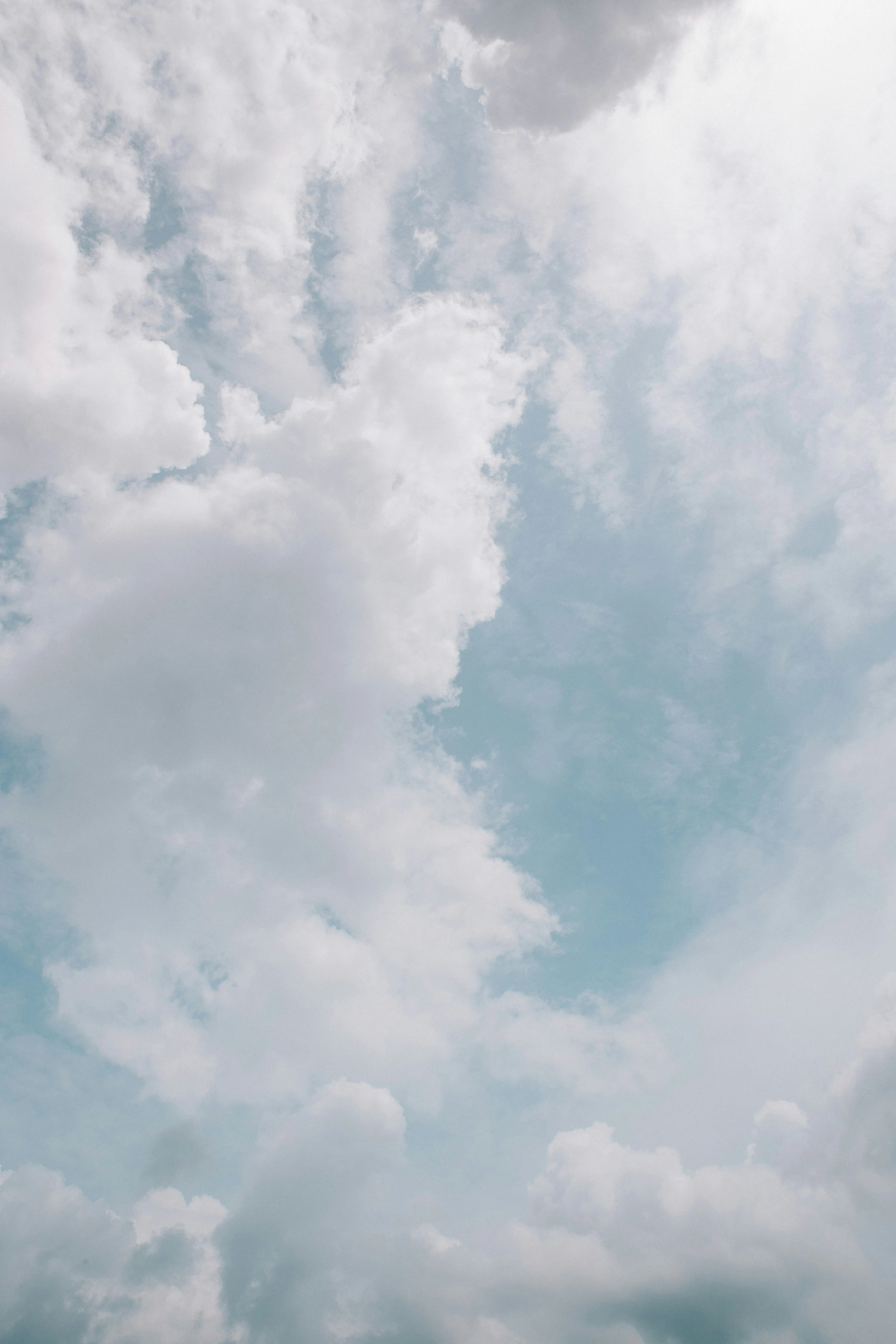 Tall White Clouds Rising Into the Clear Blue Sky Image