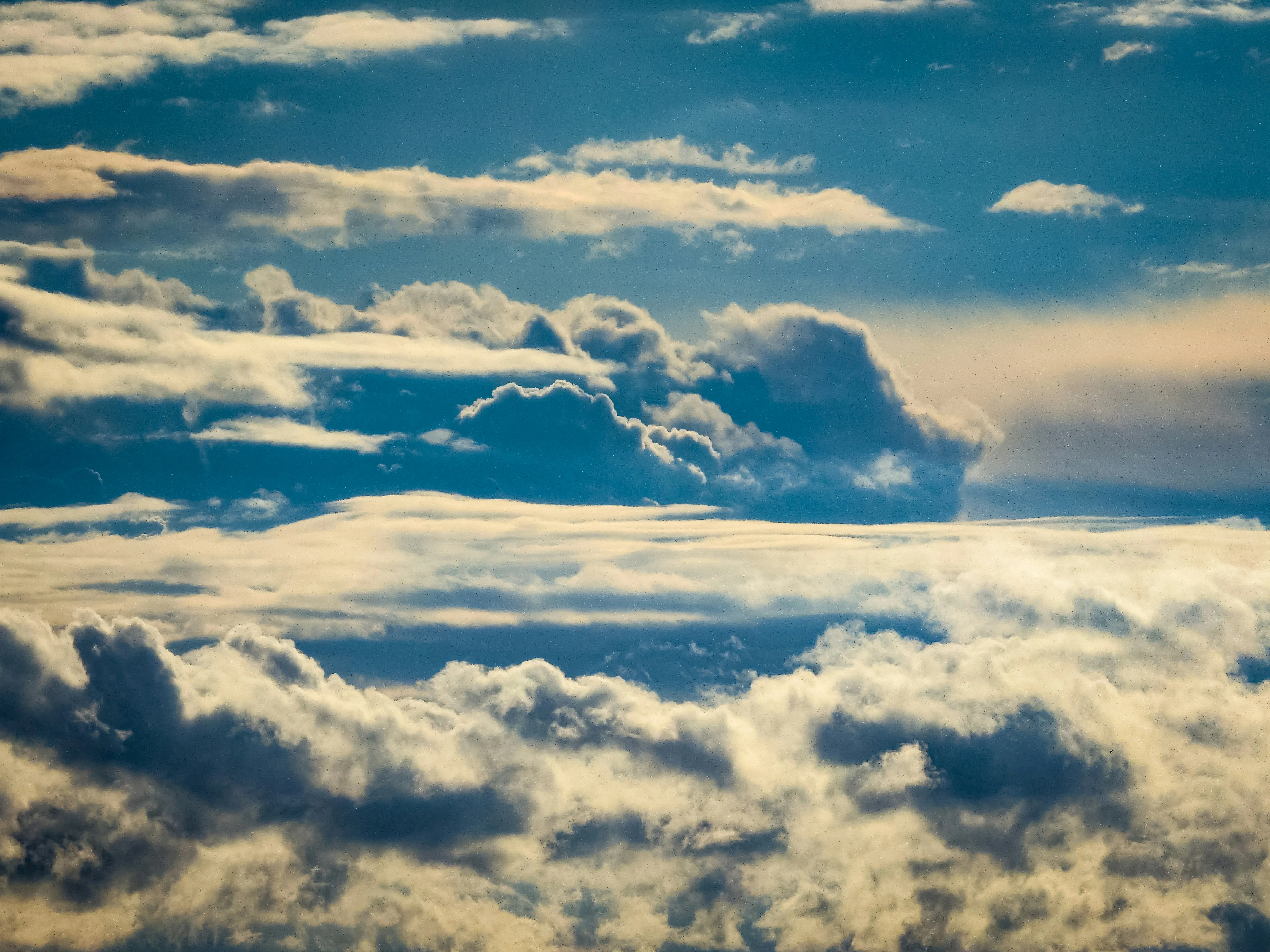 Thick Clouds Floating Above Horizon with Blue Sky Image