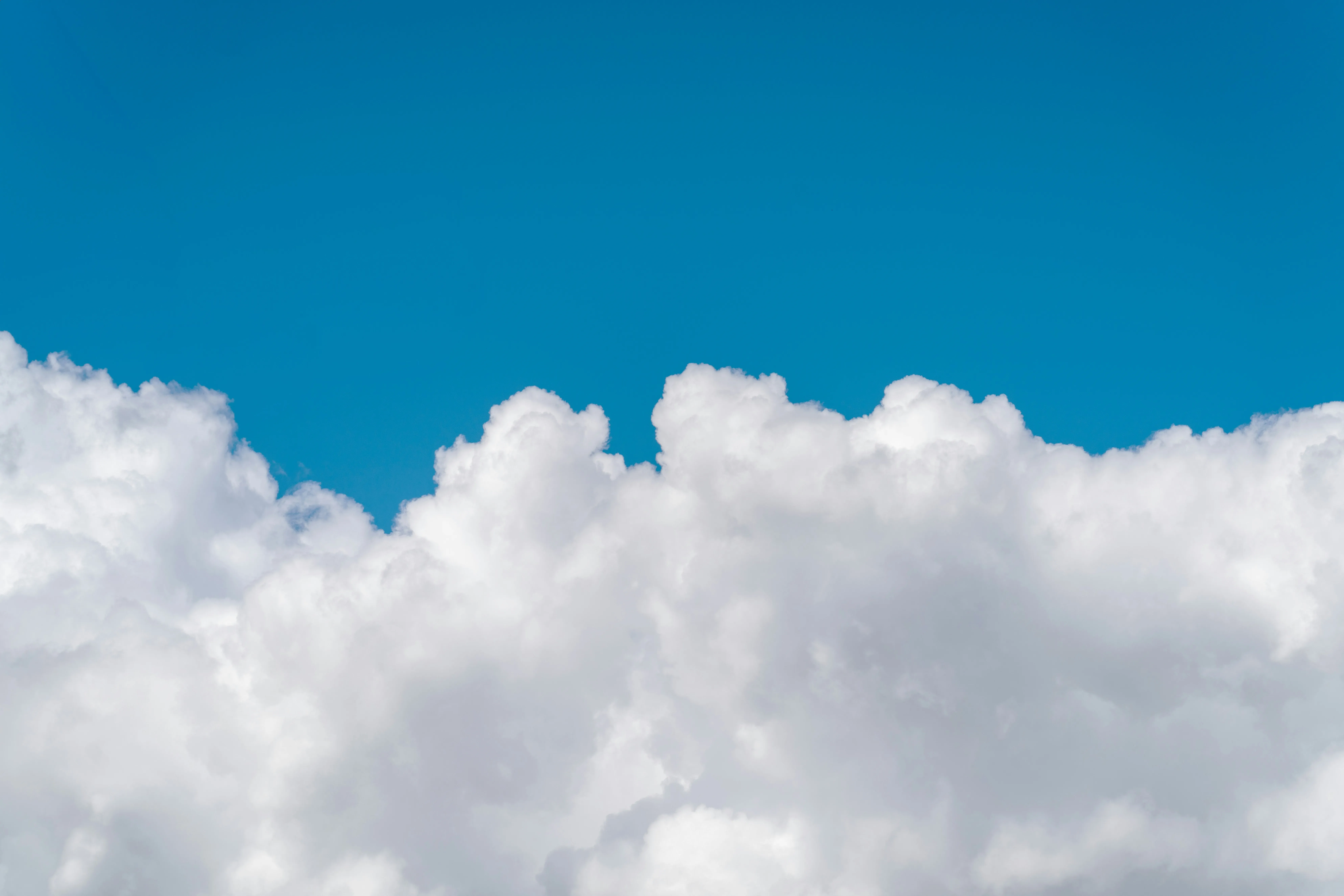Thick White Clouds Set Against a Bright Blue Sky Landscape