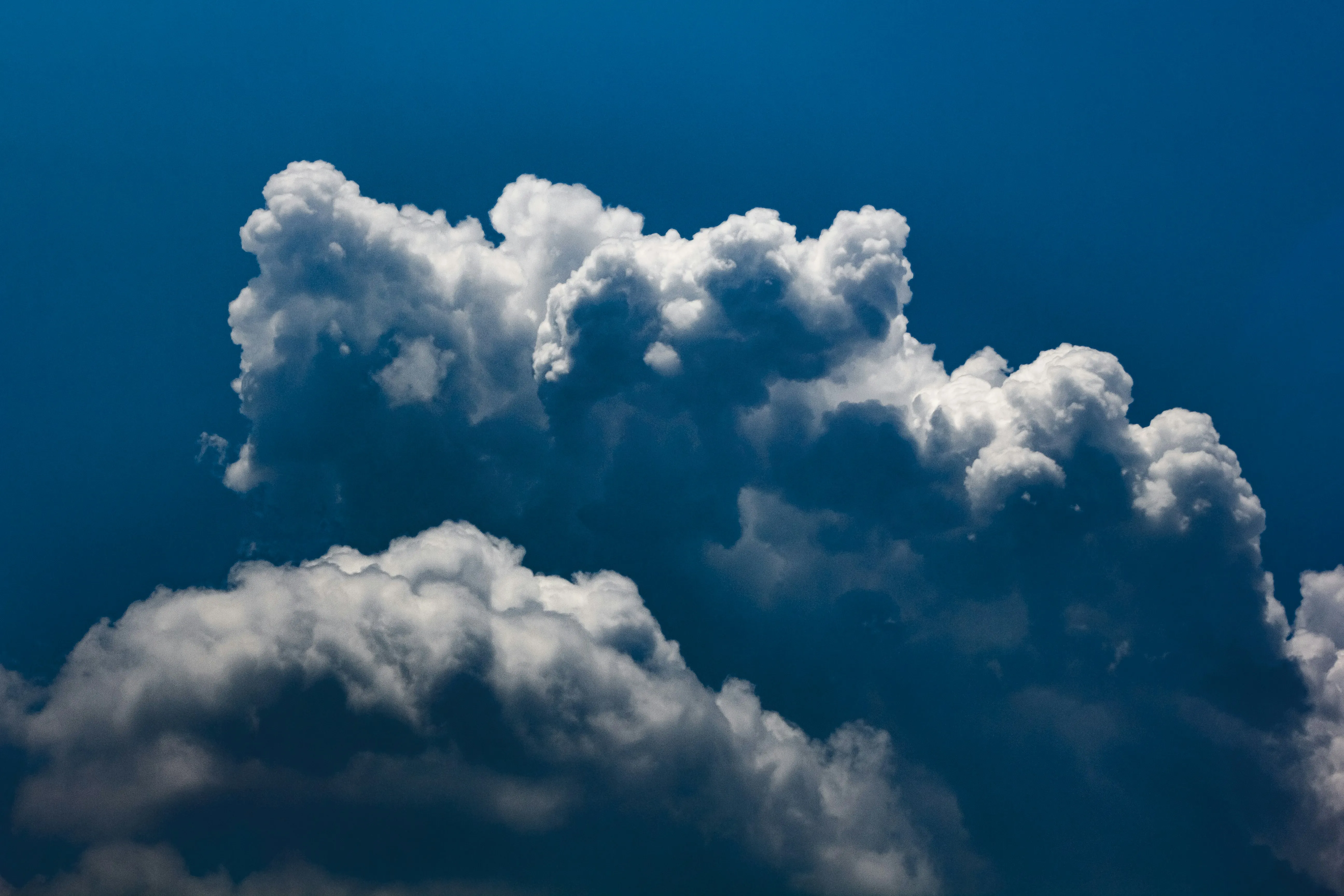 Towering Clouds Forming Over Dark Blue Afternoon Sky