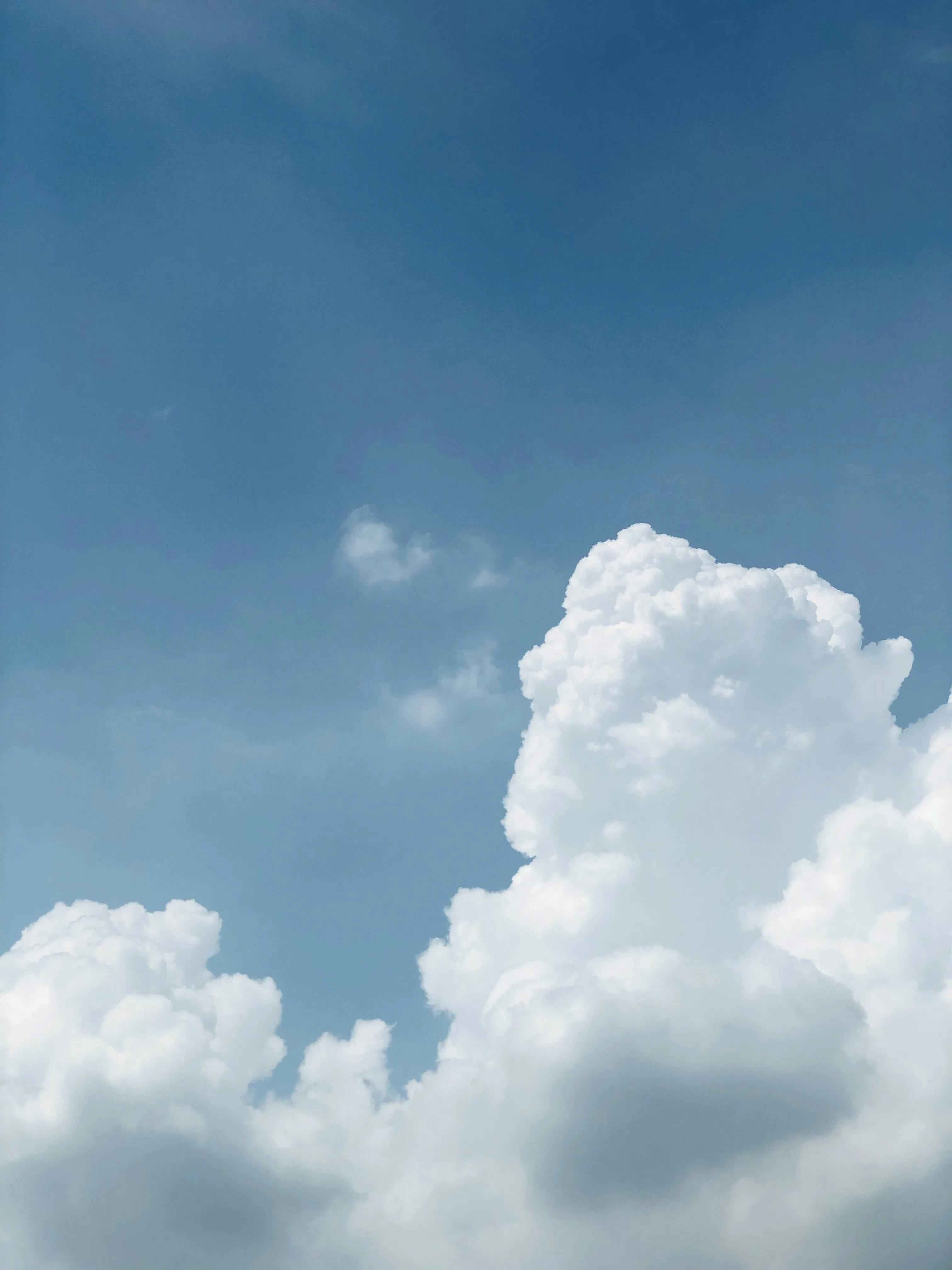 Towering Cumulus Cloud Rising in Clear Blue Sky Image