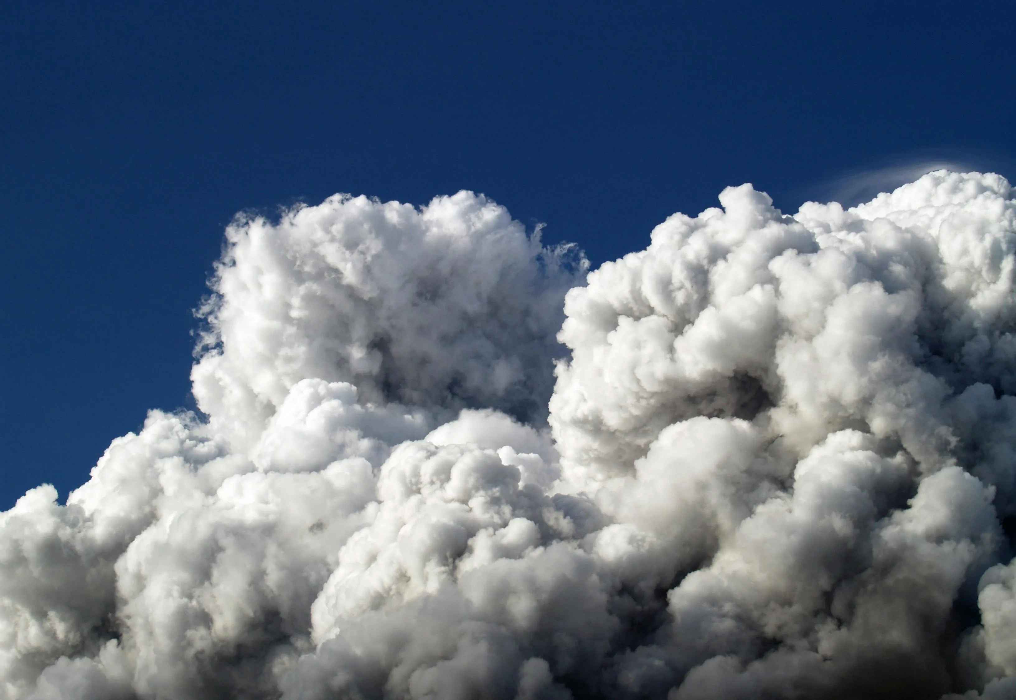 Towering Cumulus Clouds Forming Against Blue Sky Image