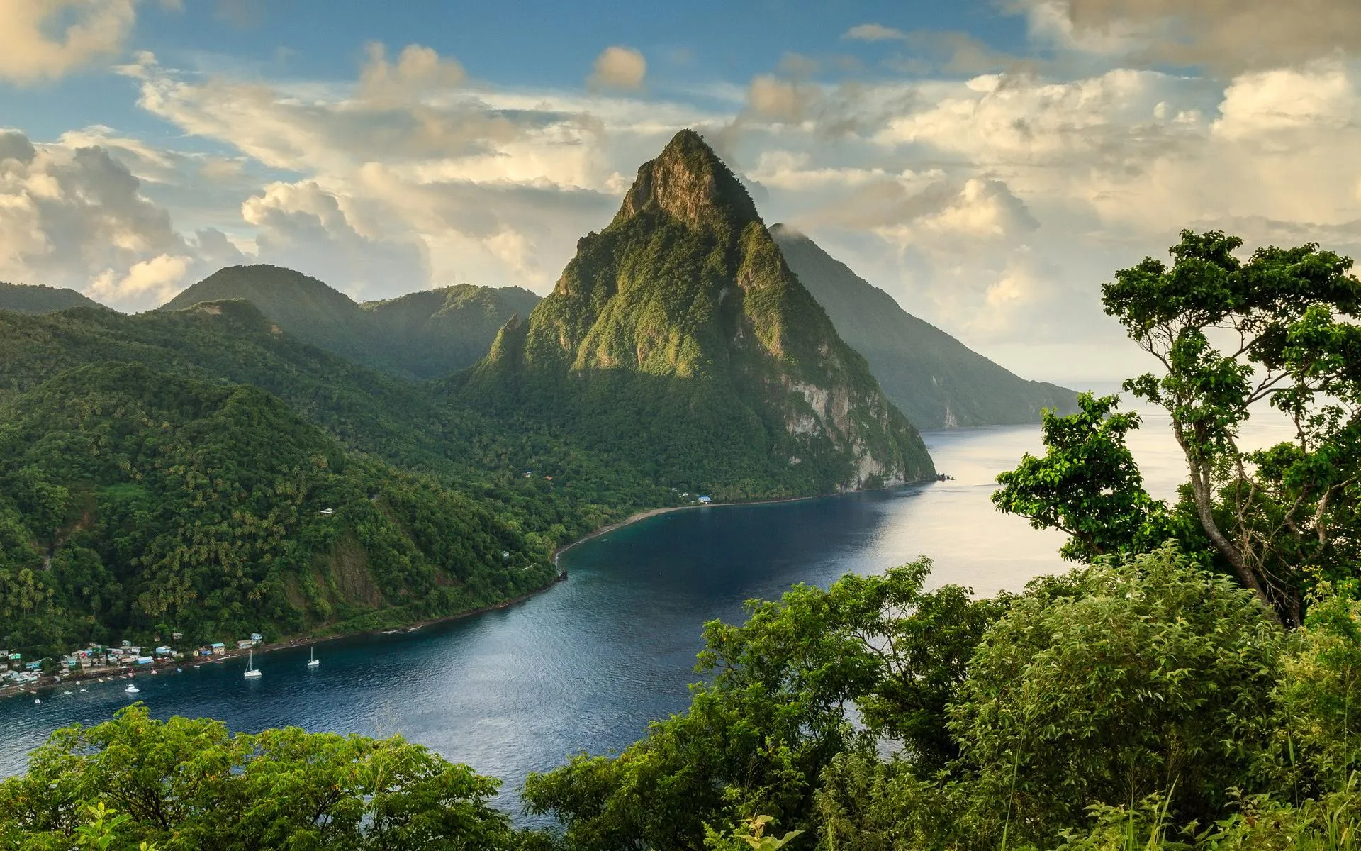 Towering Mountain Peak Overlooking Green Forest and Lake