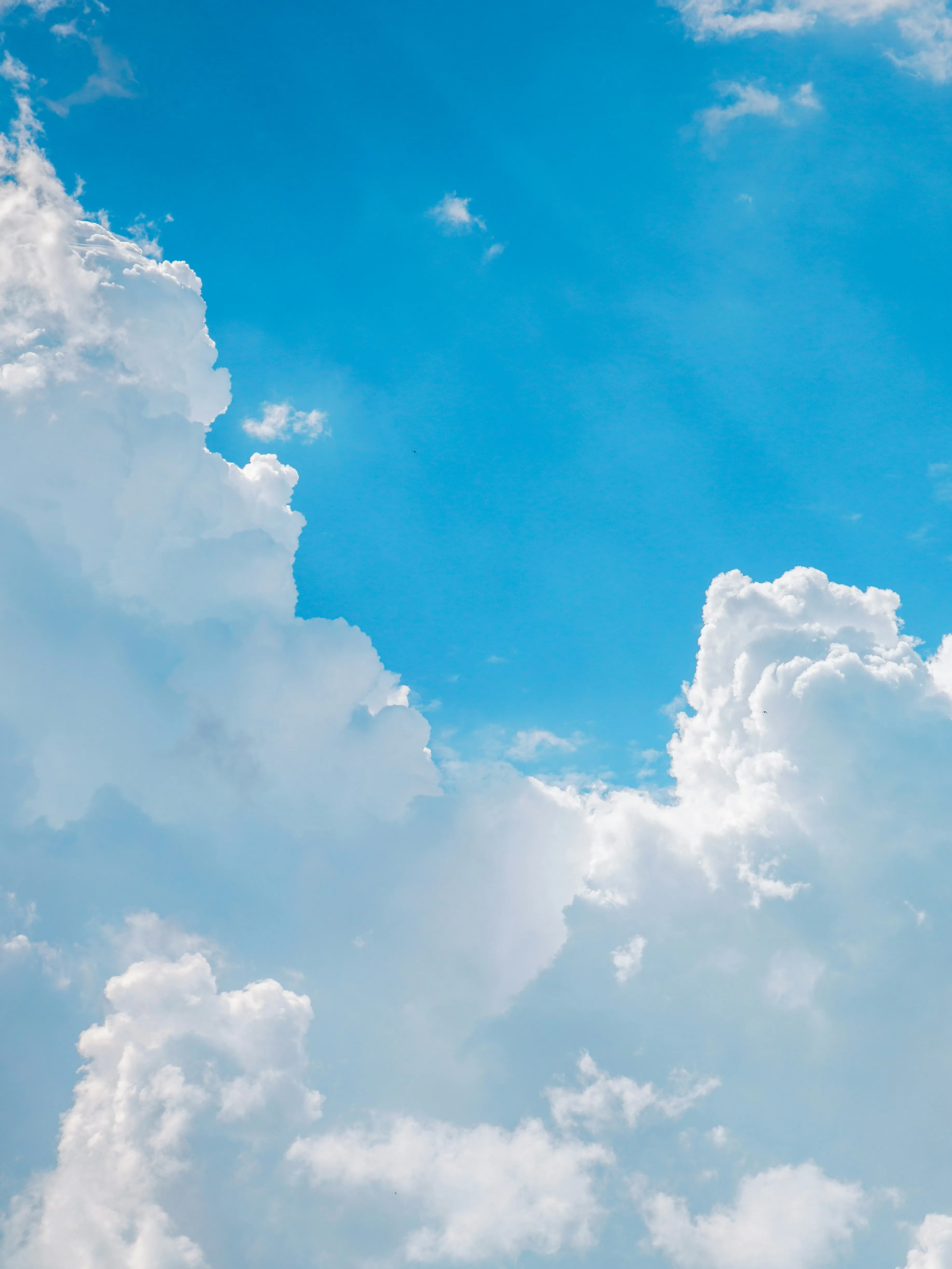 Towering White Clouds in a Bright Blue Summer Sky Wallpaper