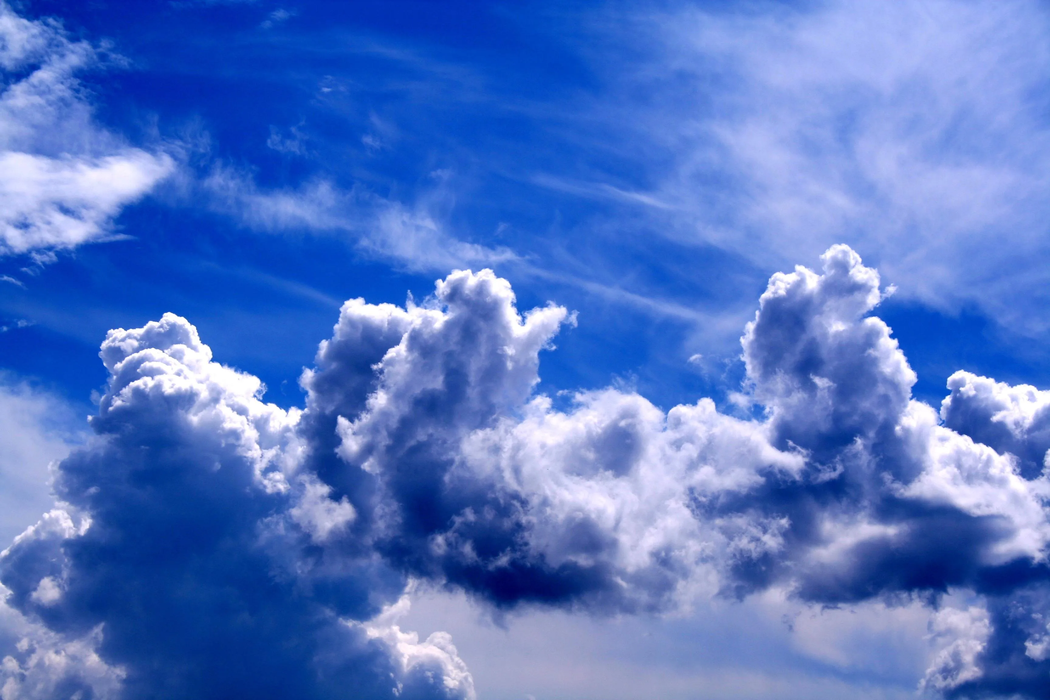 Towering White Clouds in Bright Blue Afternoon Sky Image