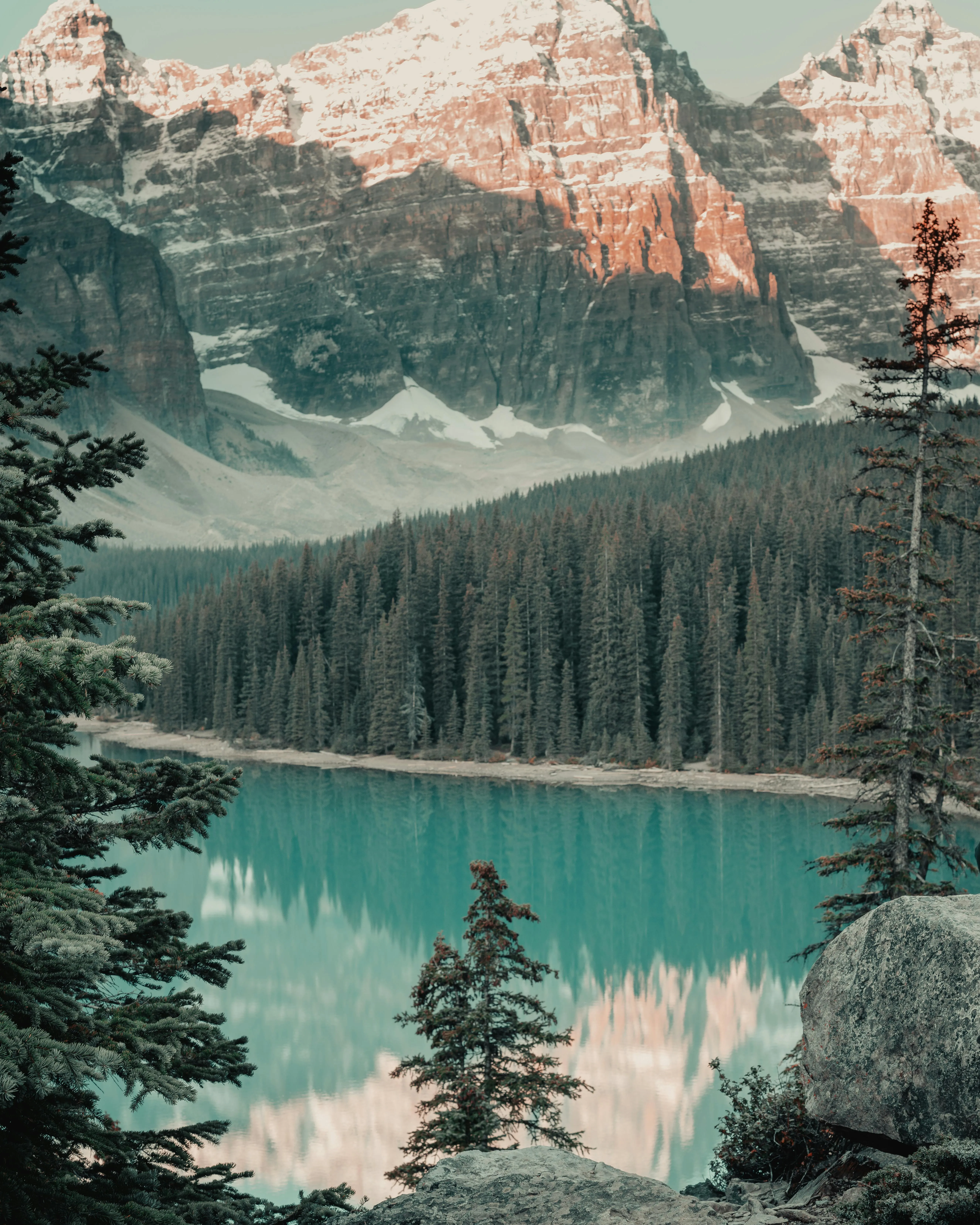 Turquoise Lake Surrounded by Forest and a Snowy Mountain