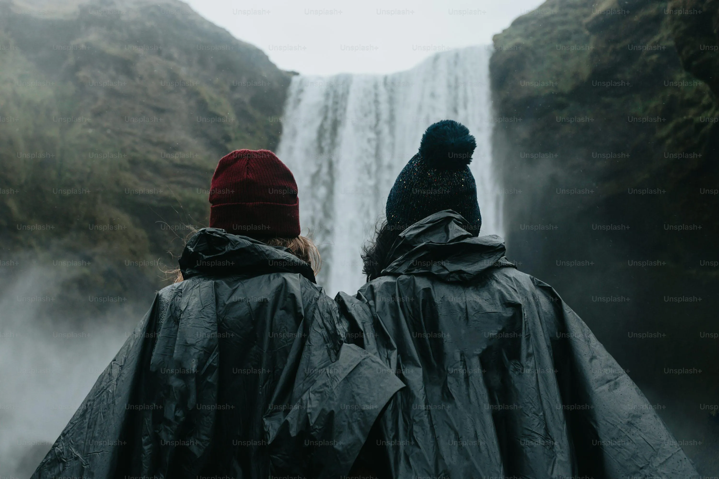 Two People Walking in Rain with Hooded Jackets