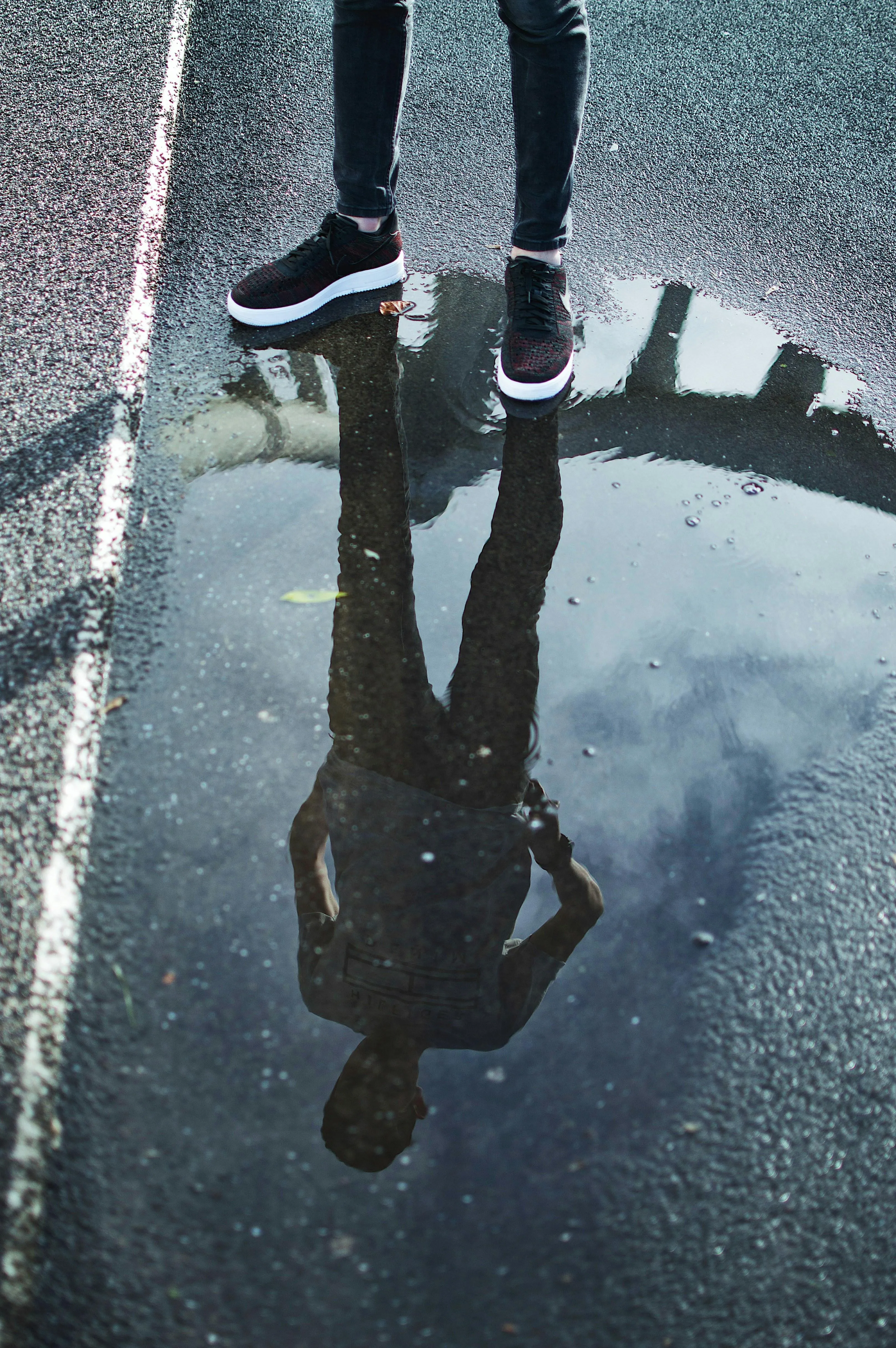 Upside Down Reflection of Woman Walking in Rain Wallpaper