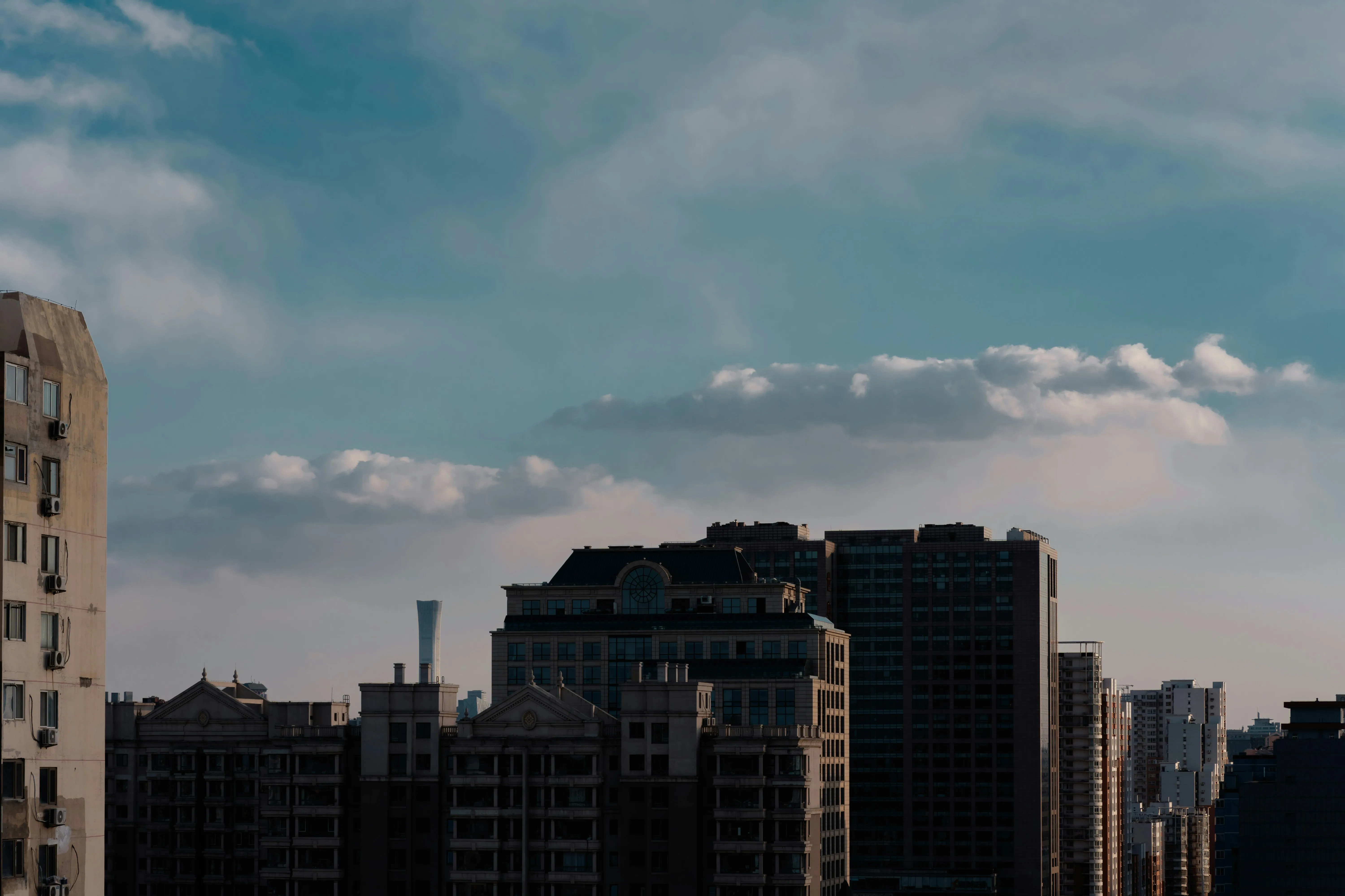 Urban Skyline Under Cloudy Sky with Buildings in View