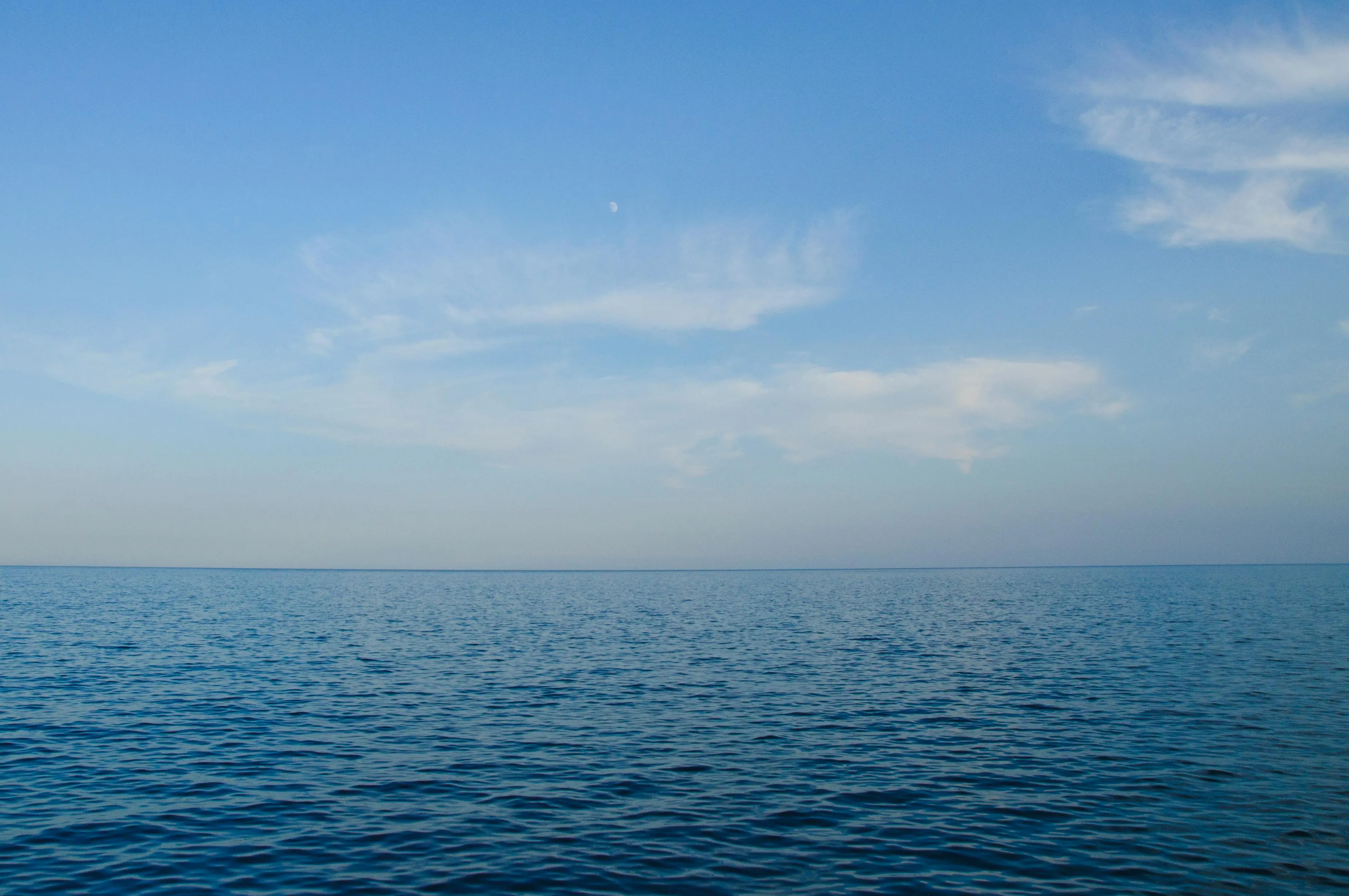 Vast Blue Ocean Under Clear Sky Stretching To the Horizon