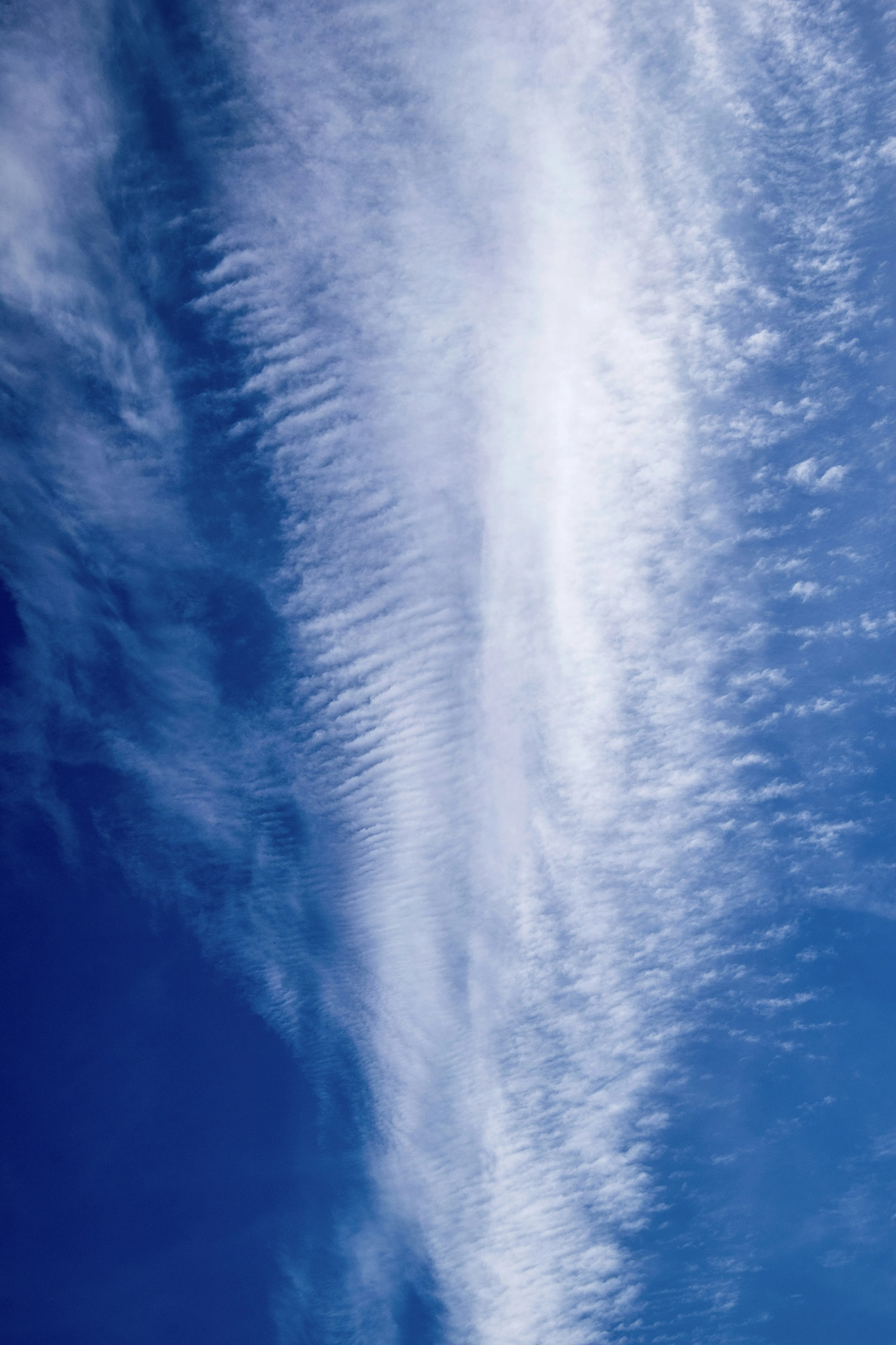 Vertical Streaks of Clouds in Vivid Blue Sky Wallpaper