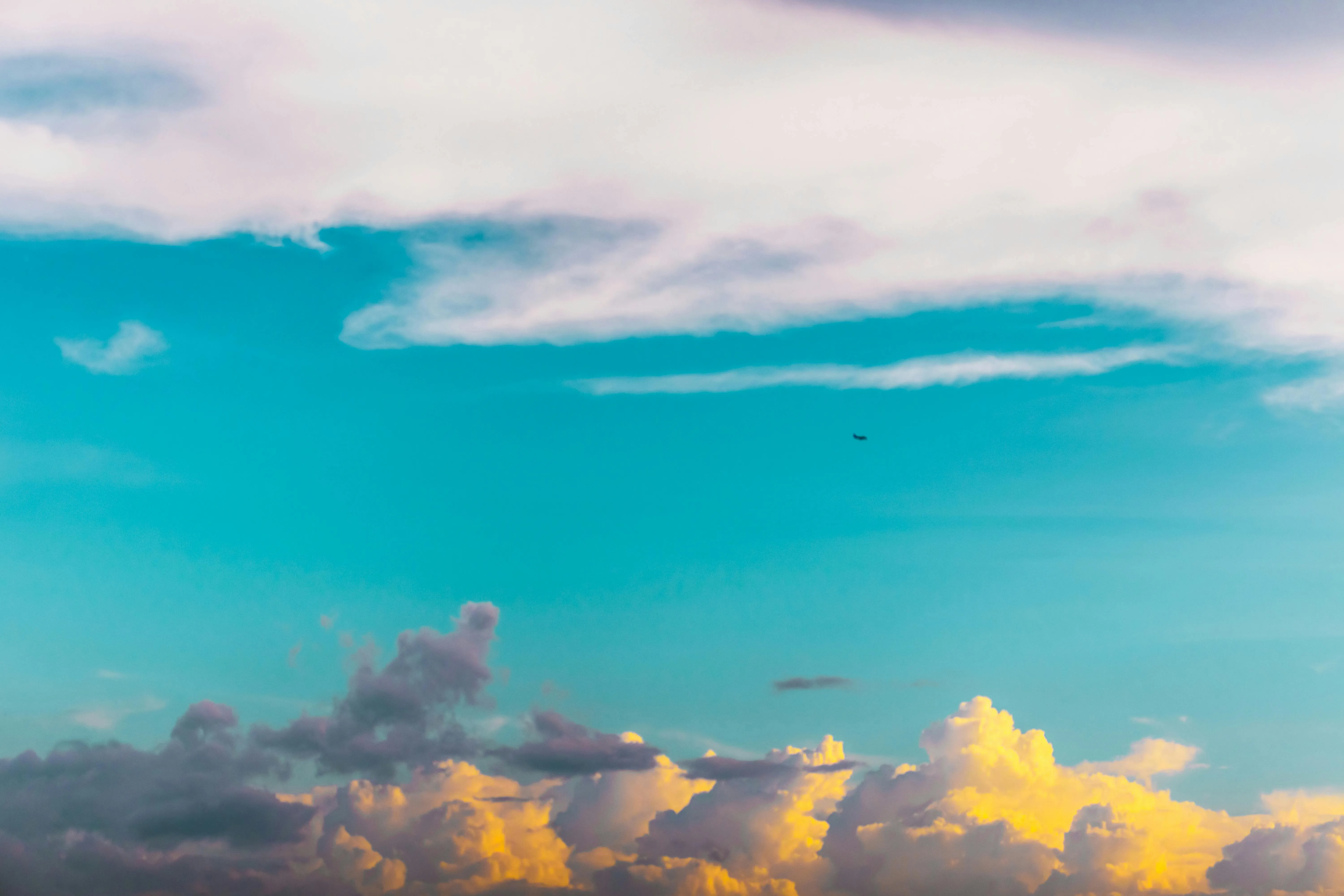 Vibrant Blue Sky with White and Orange Clouds at Sunset
