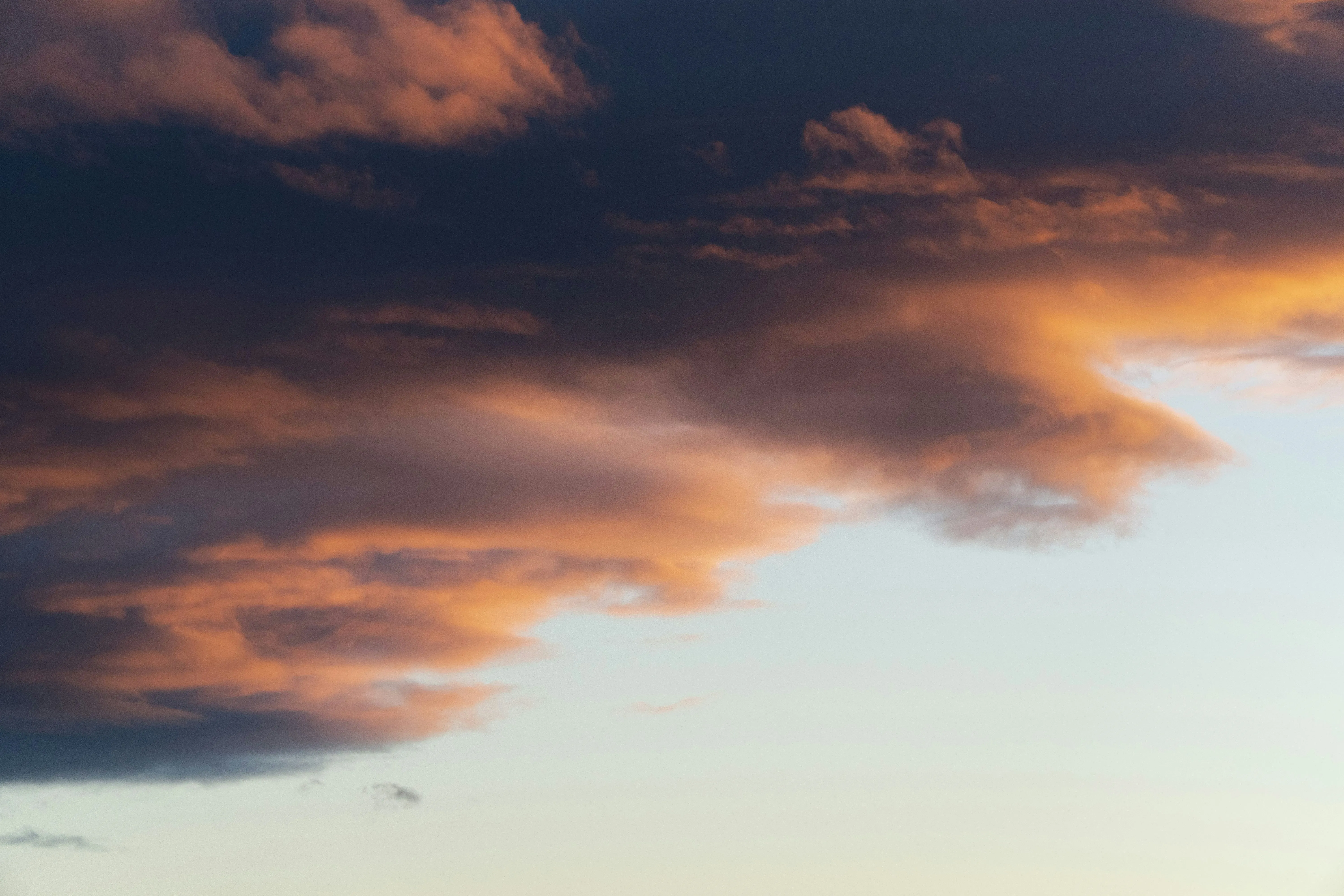 Vibrant Clouds Lit By Sunset in Orange and Pink Wallpaper