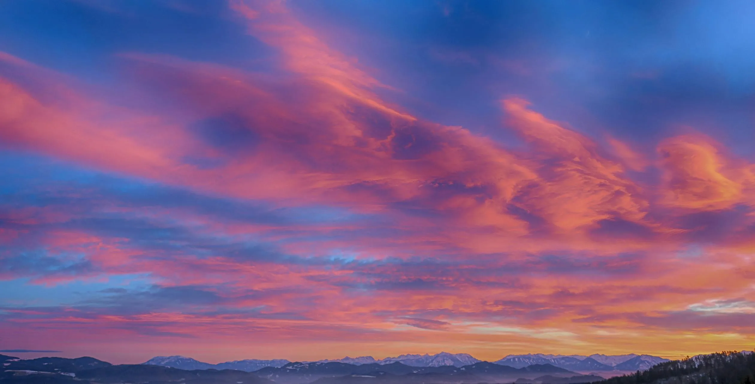 Vibrant Pink and Blue Sunset Clouds Over the Horizon