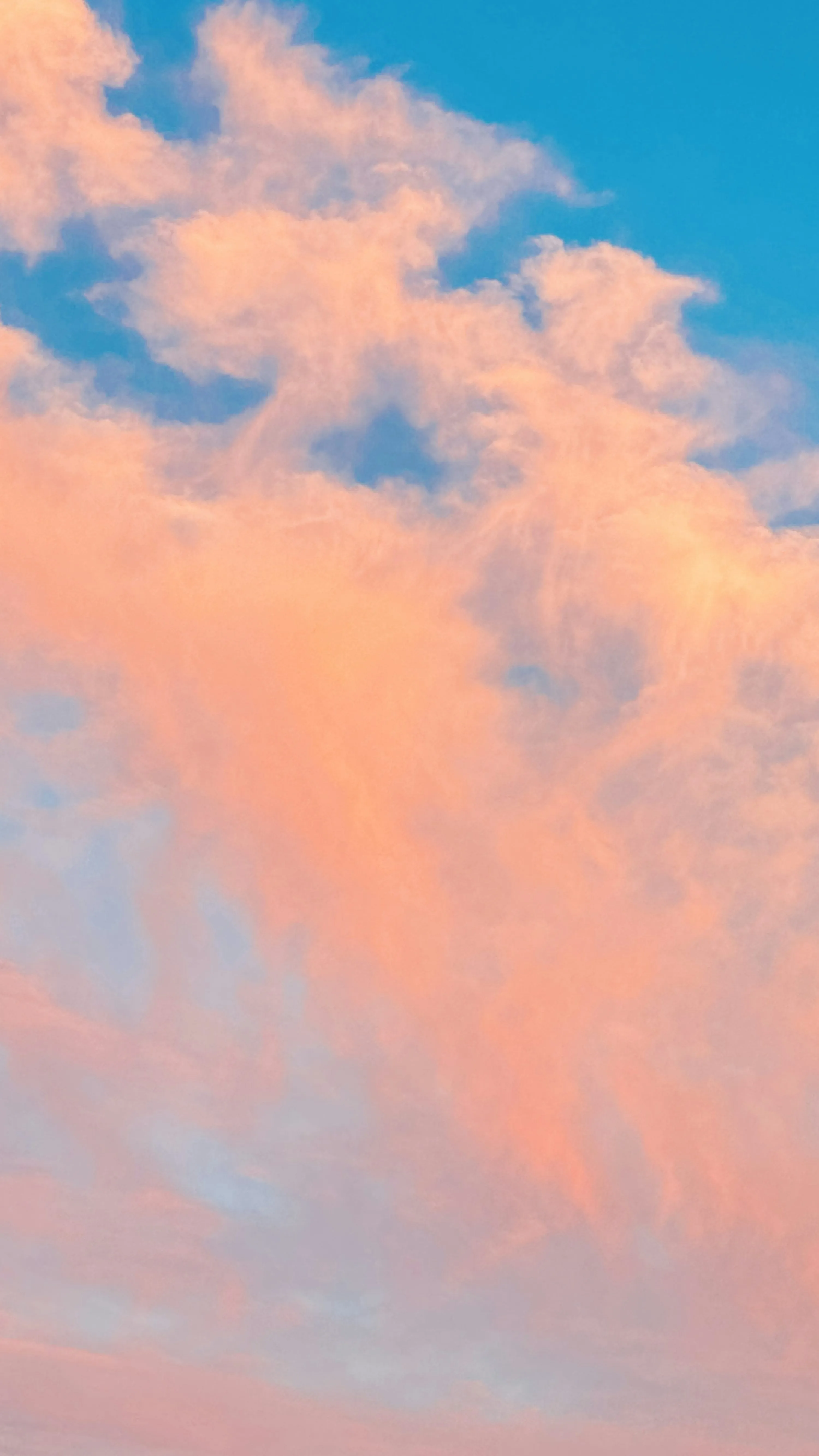 Vibrant Sunset Clouds in Shades of Pink and Blue Wallpaper