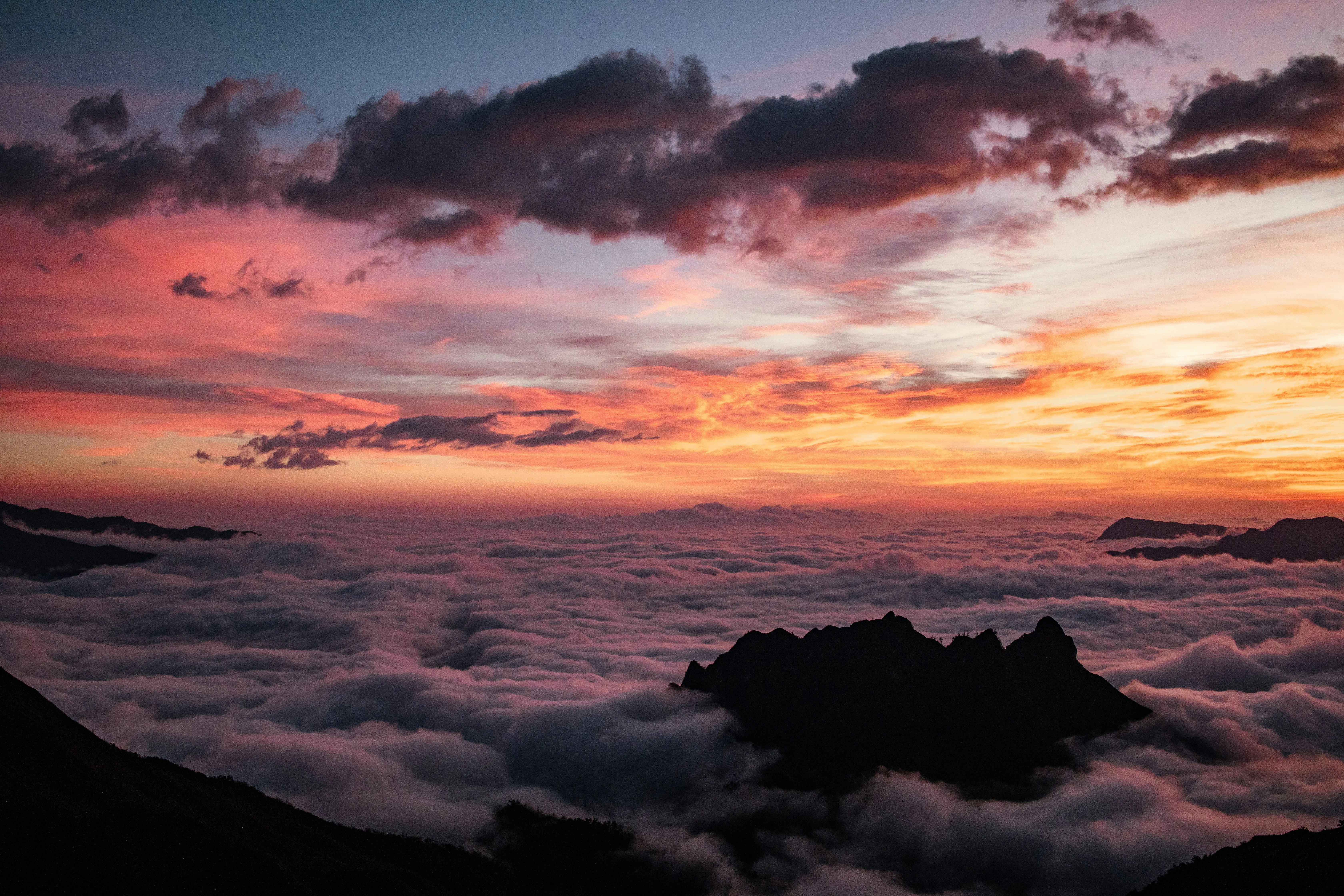 Vibrant Sunset Over Mountains Above Cloud Line Image