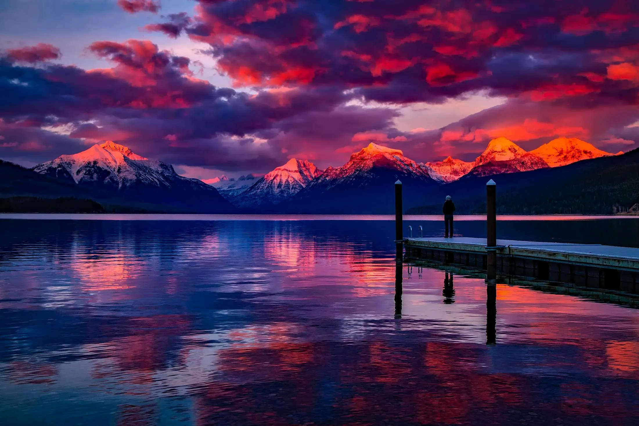 Vibrant Sunset Reflected in Lake Beside Wooden Dock