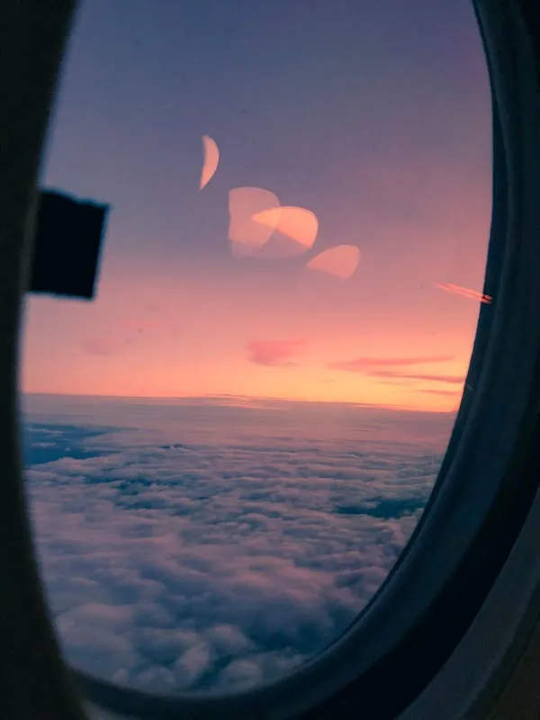 Vibrant Sunset Seen Through Airplane Window Glass Wallpaper