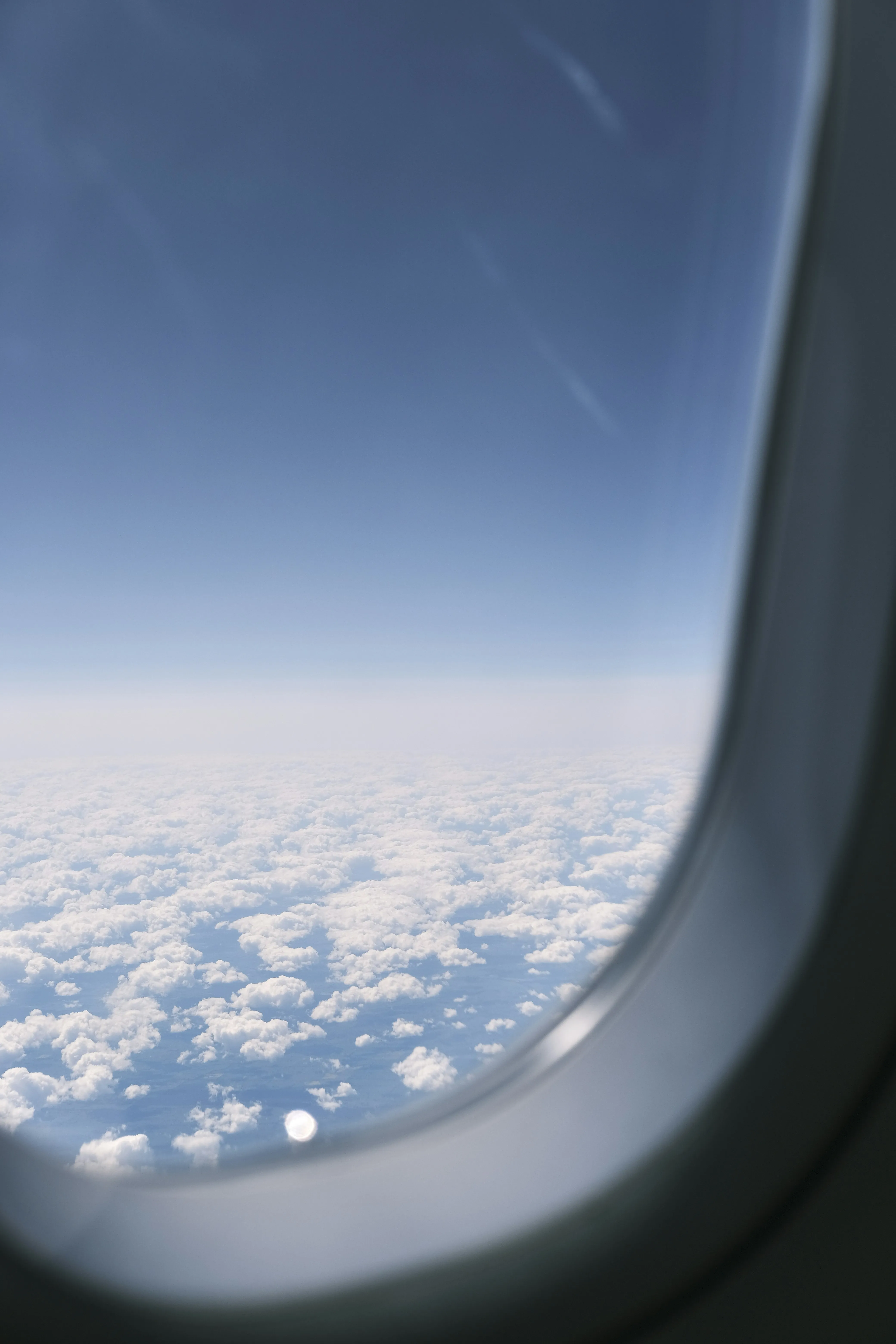 View From Airplane Window Showing Clouds and Sky