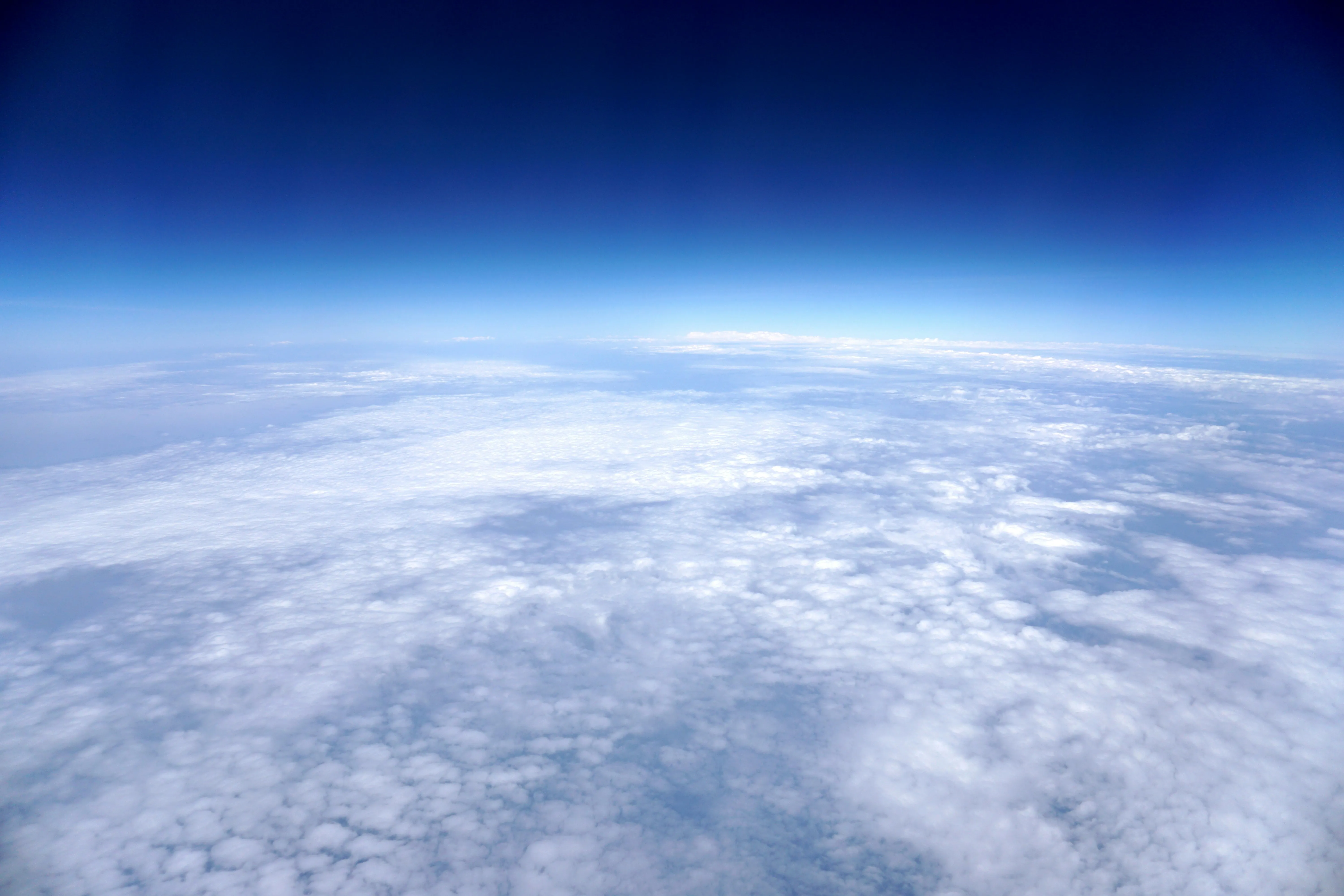 View From High Altitude Showing Clouds and Curvature of Earth