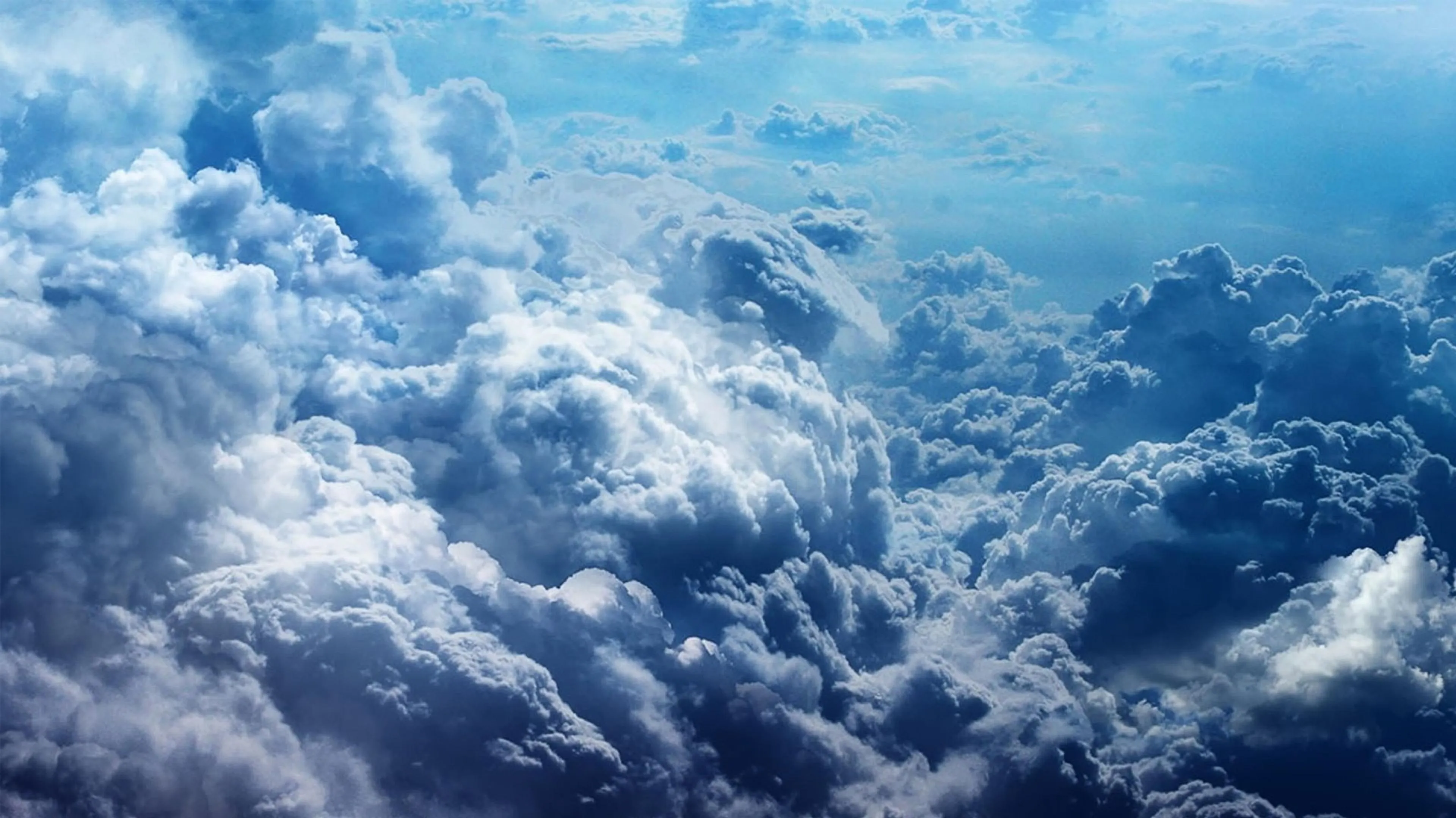 View of Thick Clouds From Above with Blue Sky Background