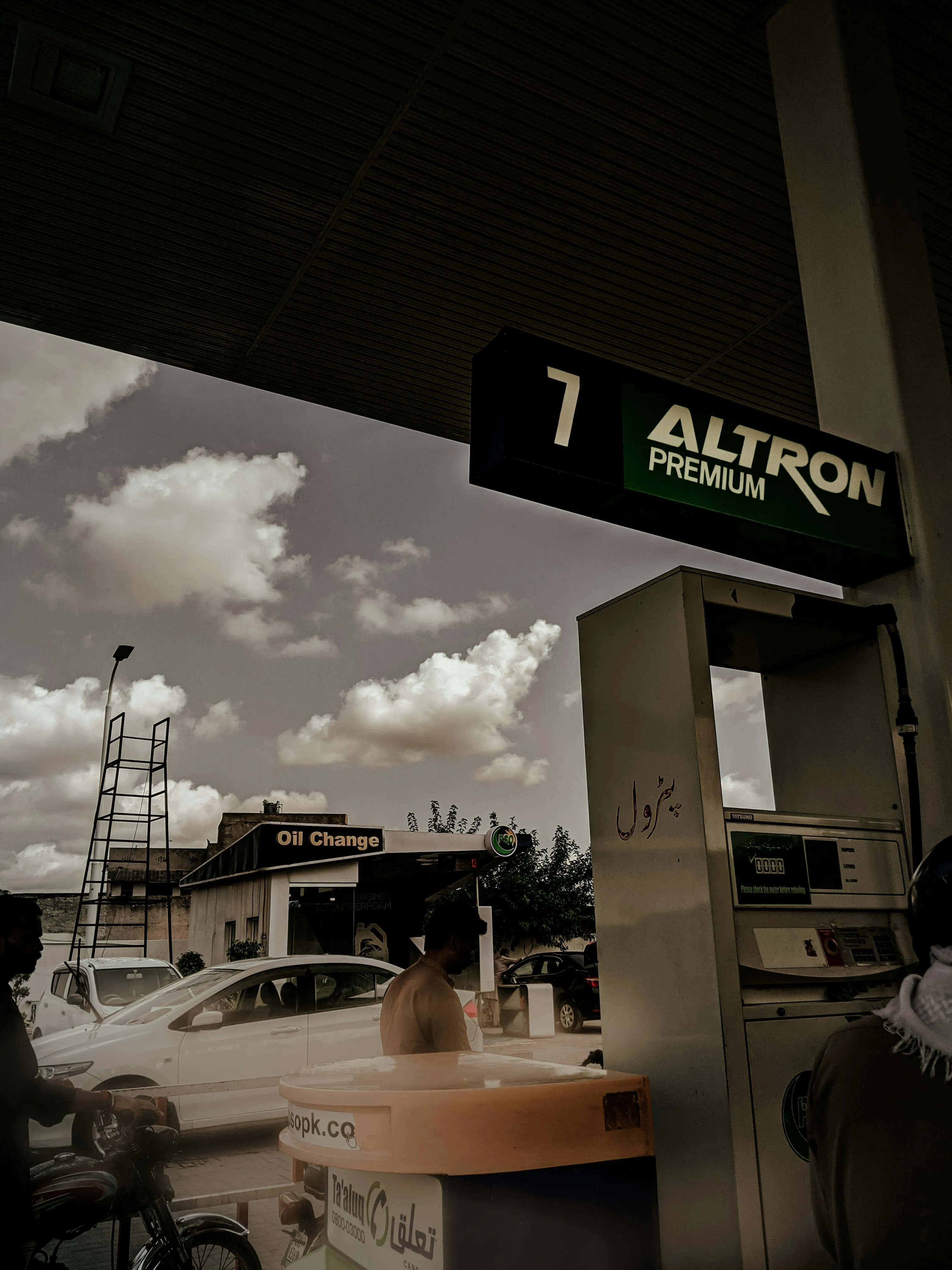 Vintage Gas Station Sign in Black and White City Scene