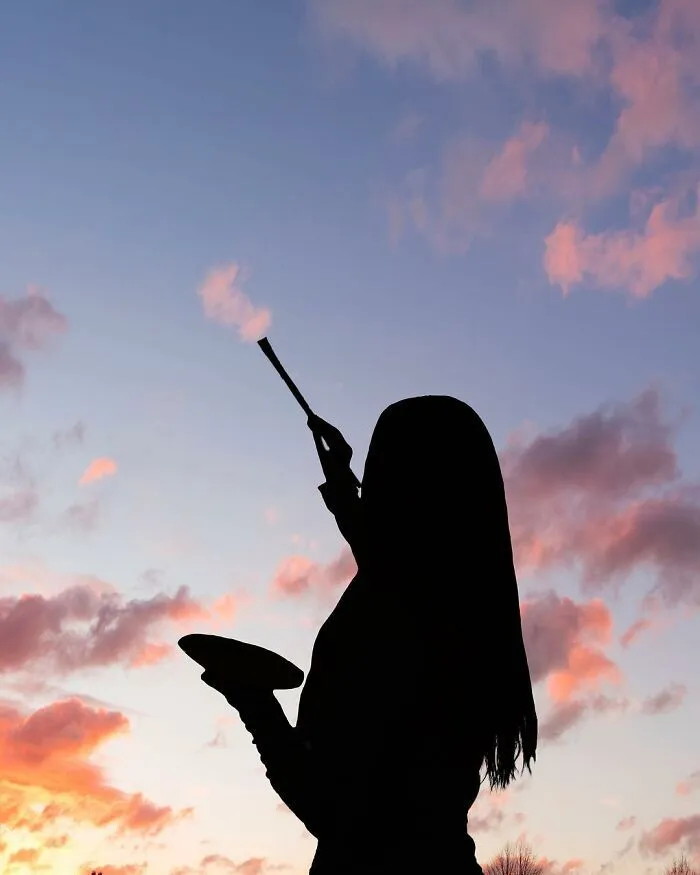 Wallpaper of Girl Playing Under Pink Twilight Clouds