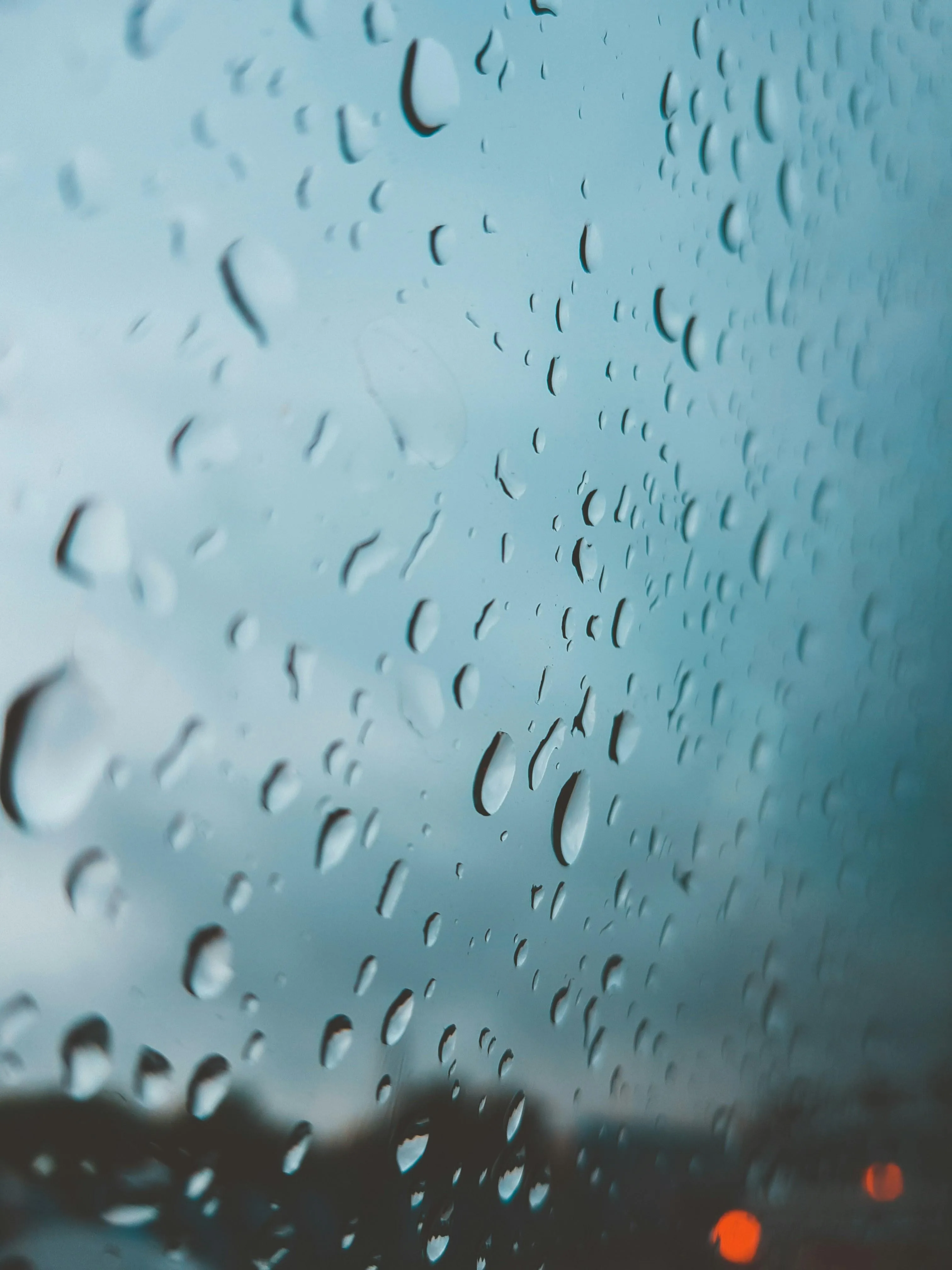 Wallpaper of Rain Drops on Window with Blurred Background