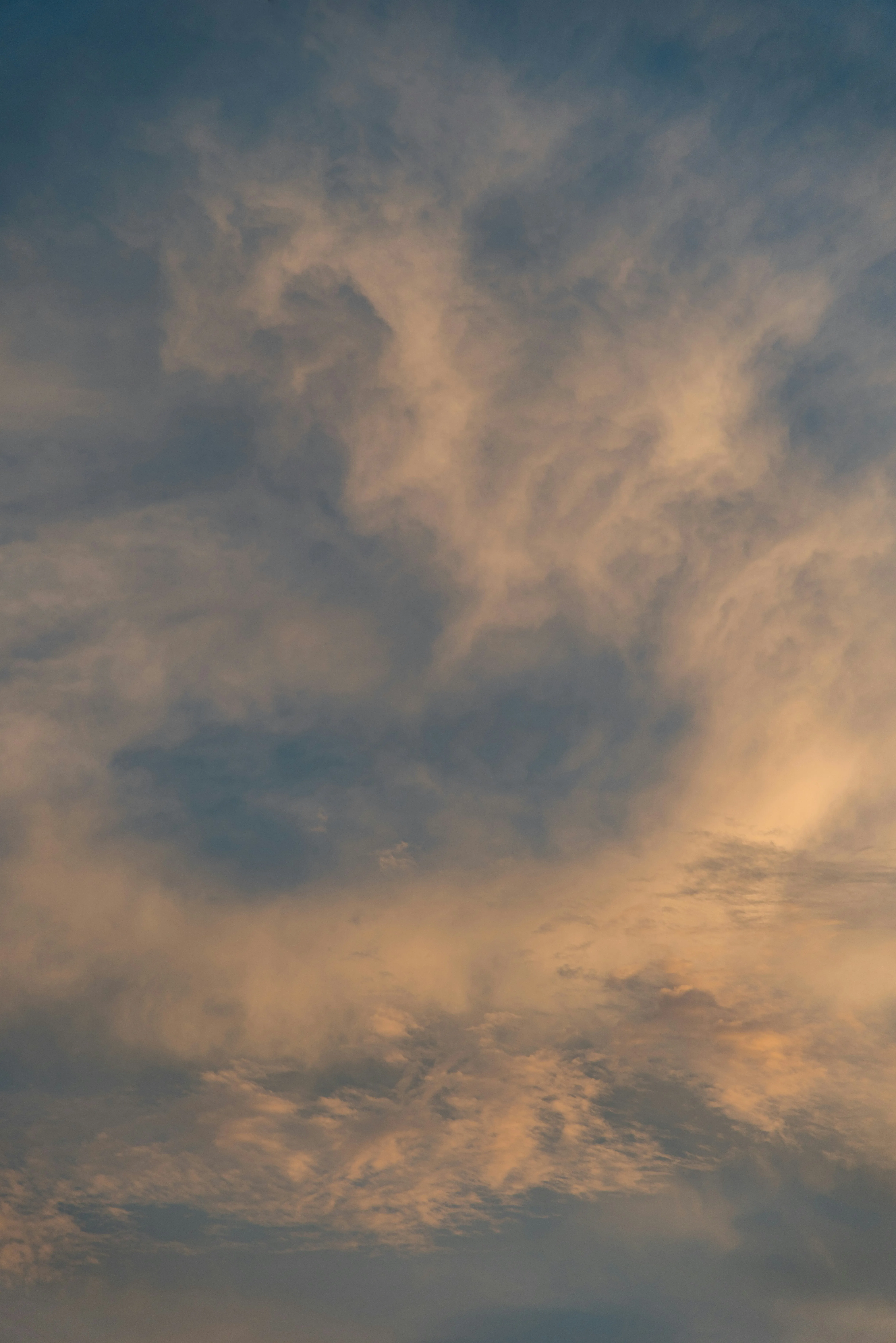 Warm Golden Sky with Scattered Clouds at Sunset Wallpaper