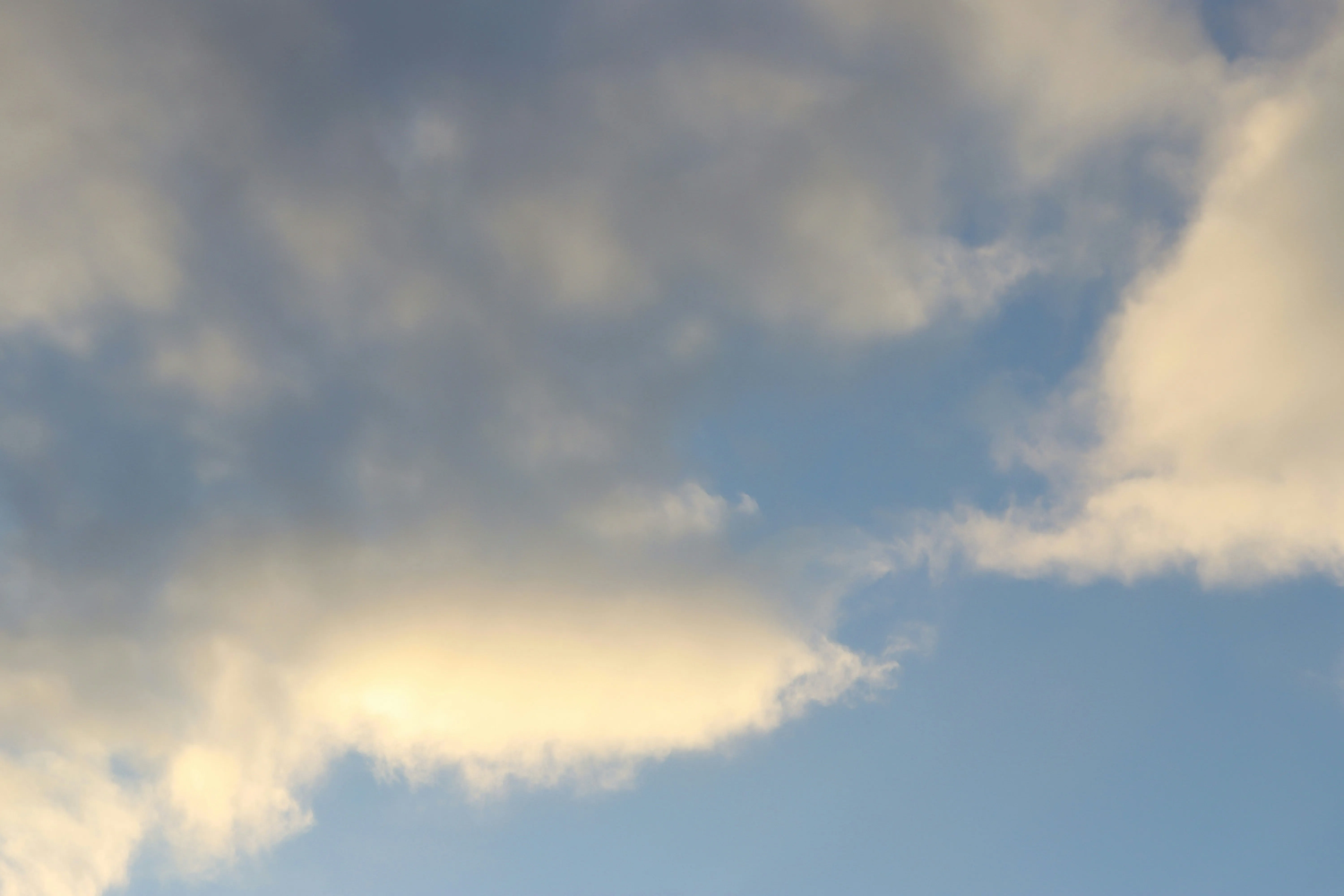 Warm Golden Sky with Soft Clouds at Sunset Image 4K