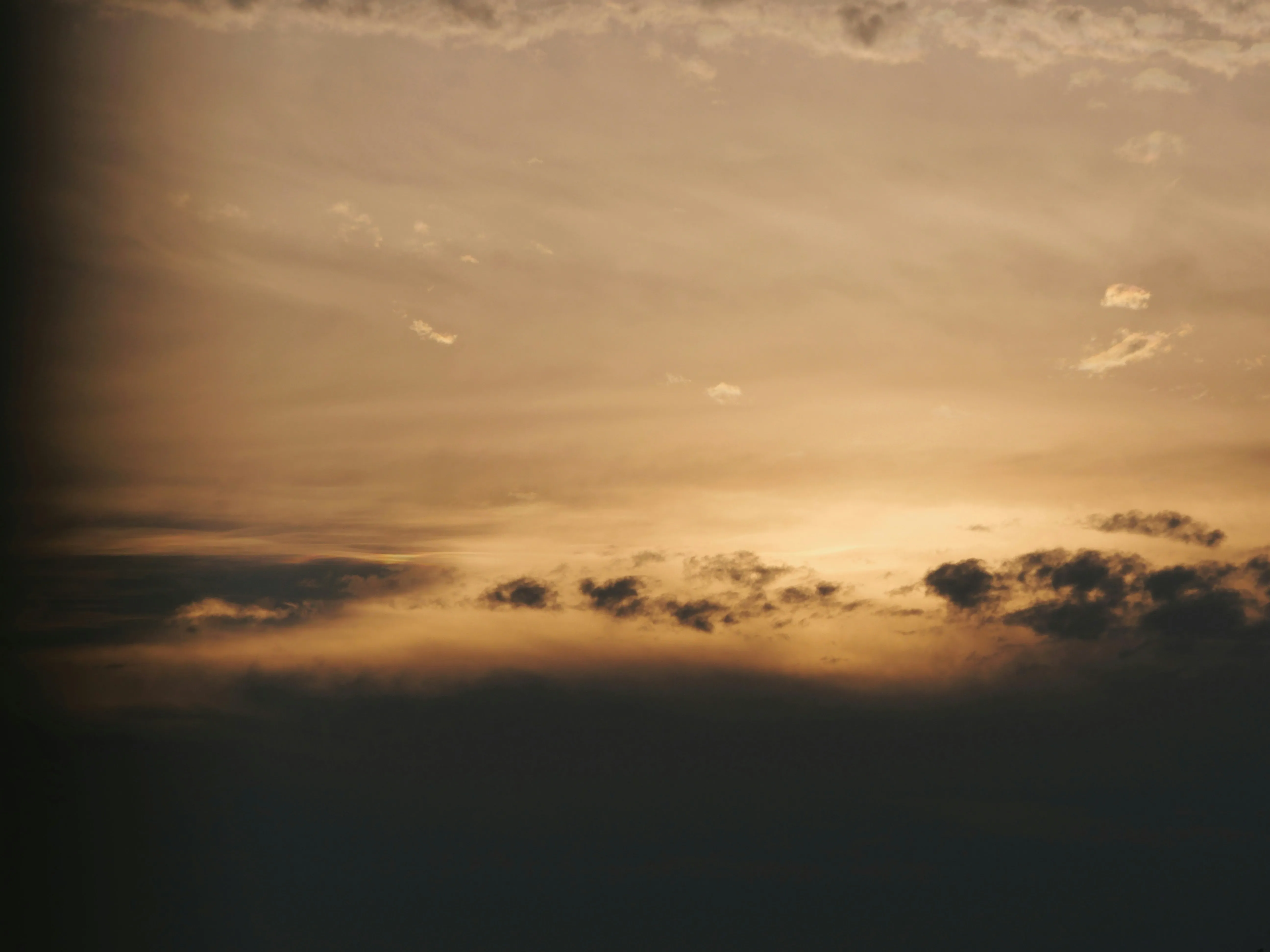 Warm Sunset Sky with Soft Clouds and Golden Light Image