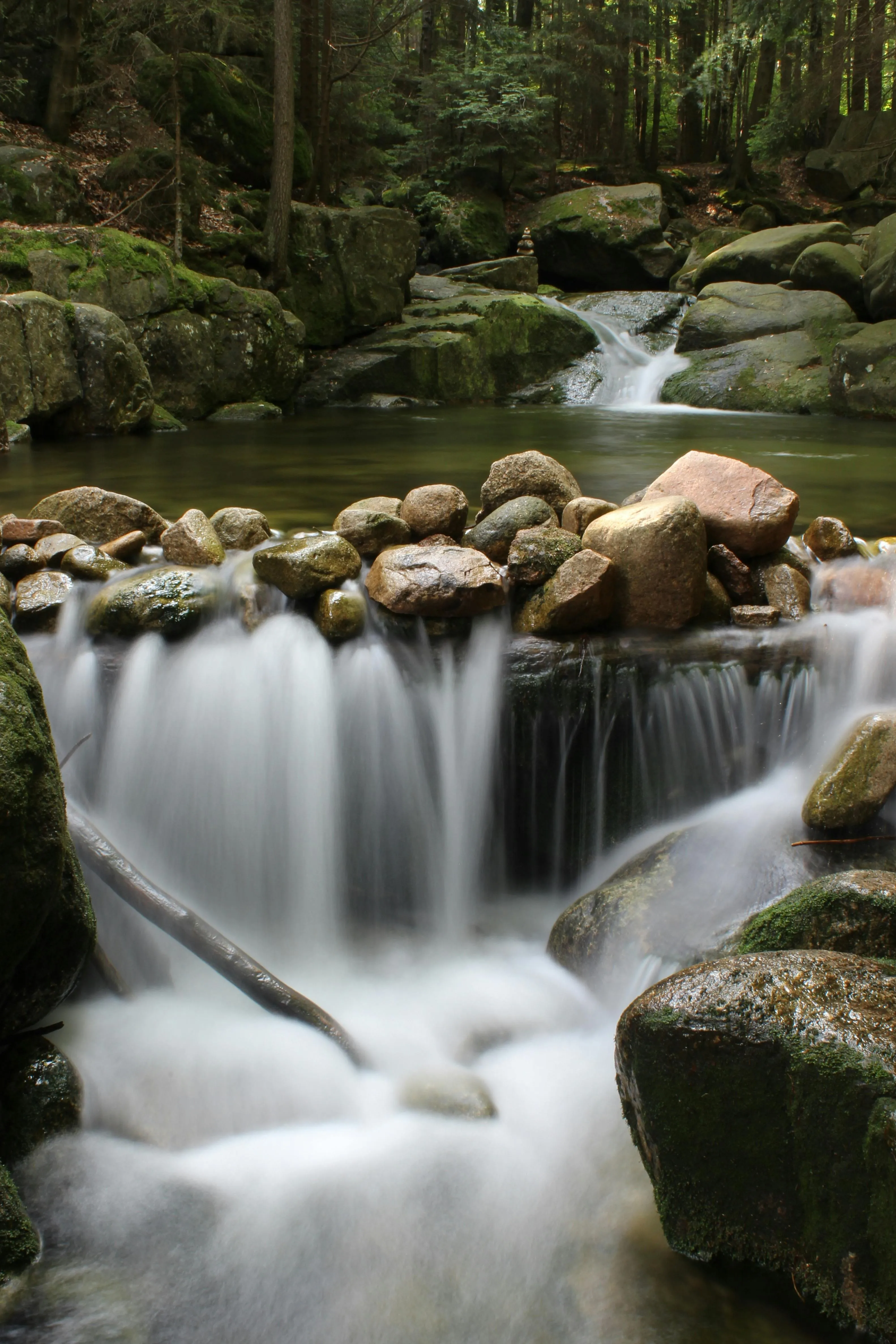 Waterfall Flowing Gently Over Rocks in a Quiet Forest