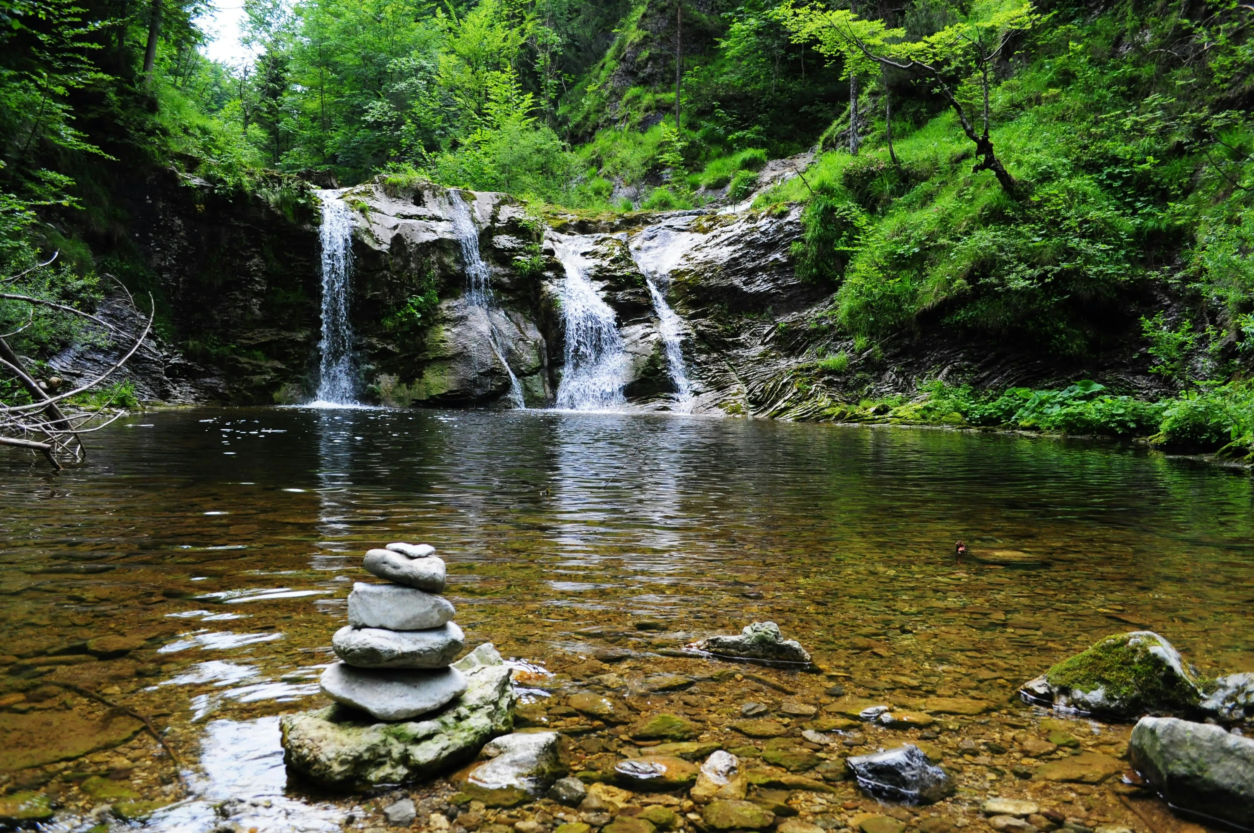 Waterfall Pool in the Forest with Balanced Stones Wallpaper