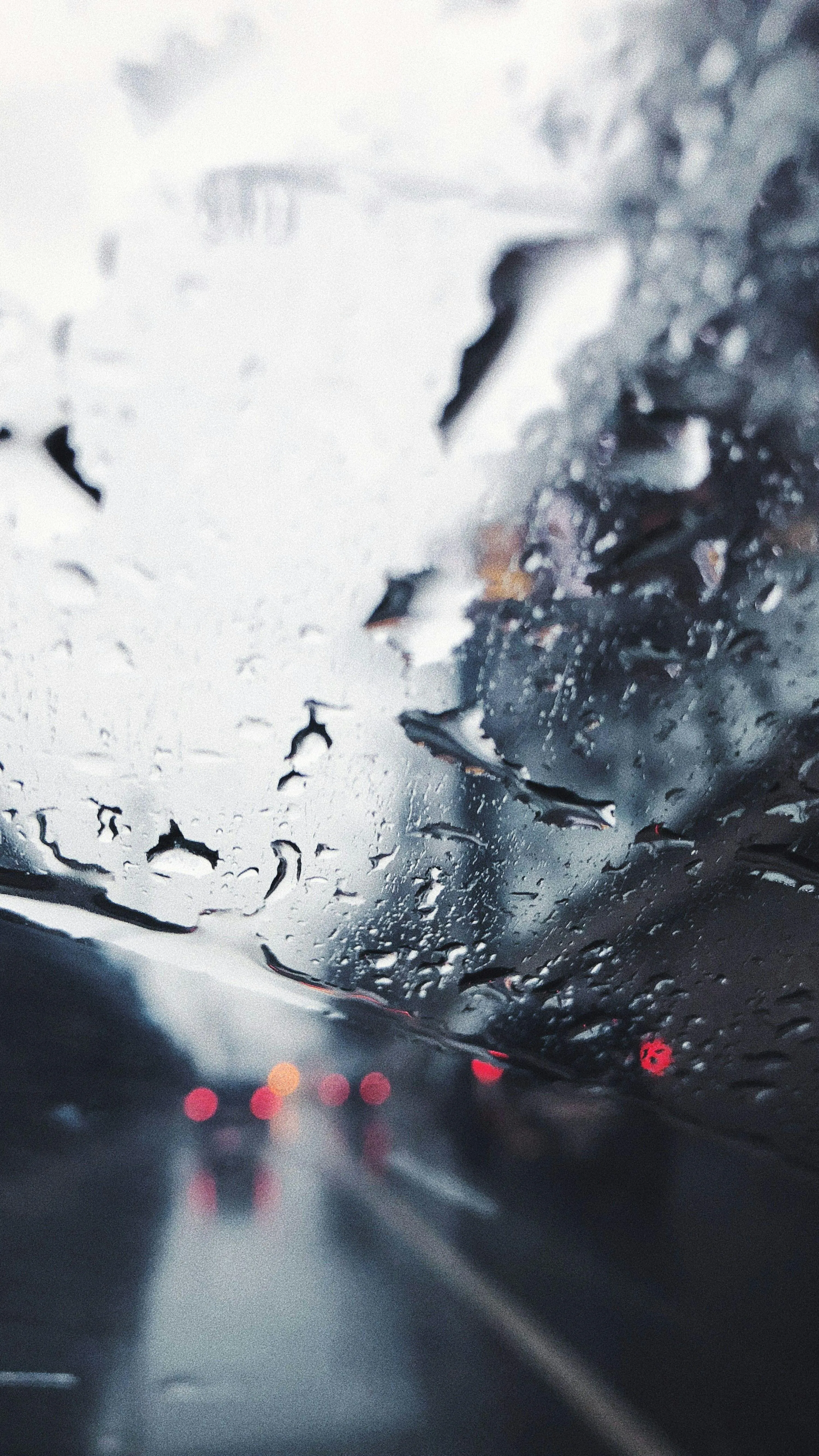 Wet Car Window Reflecting Traffic in Heavy Rain Image