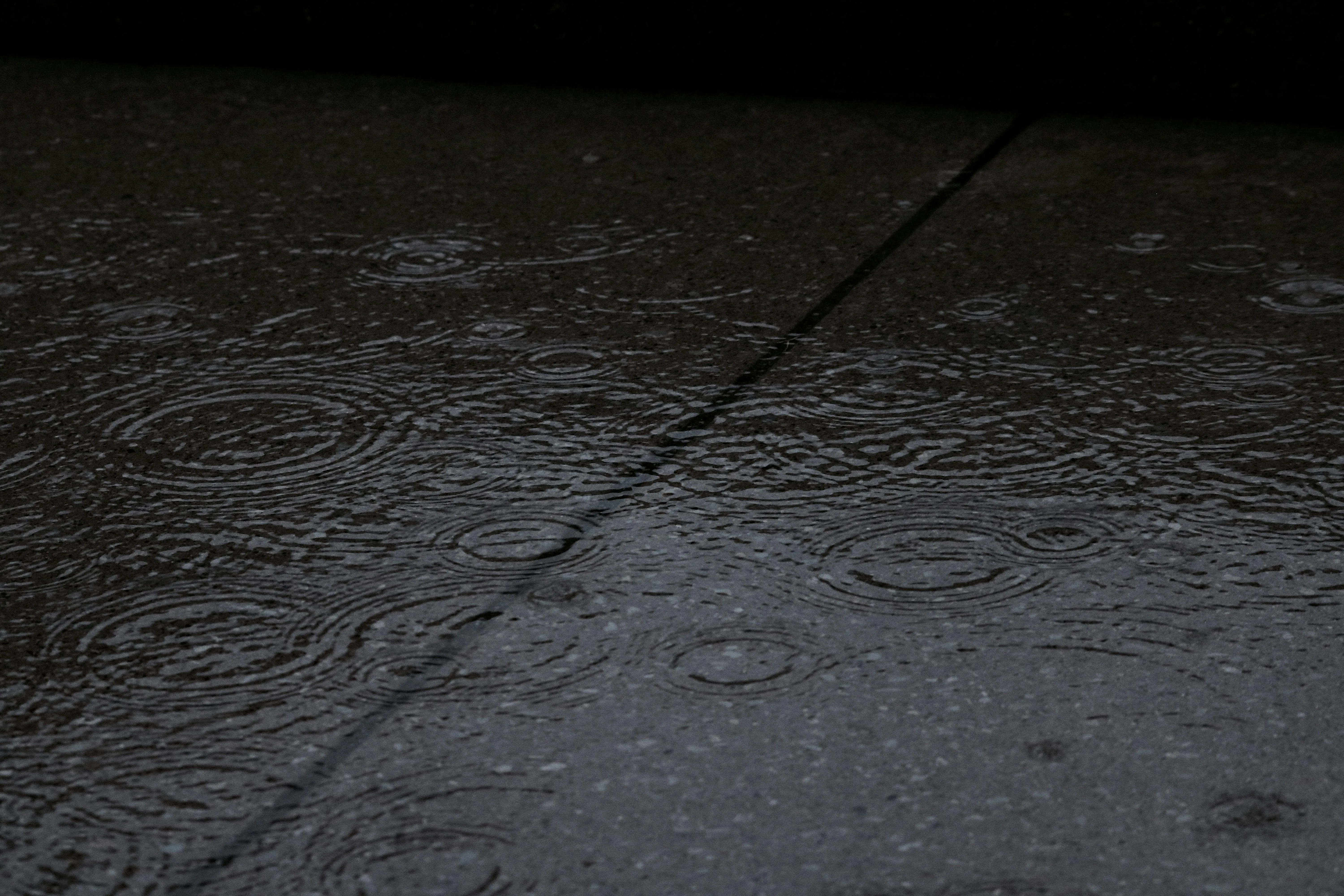 Wet Tile Surface Capturing Raindrops and Light Wallpaper
