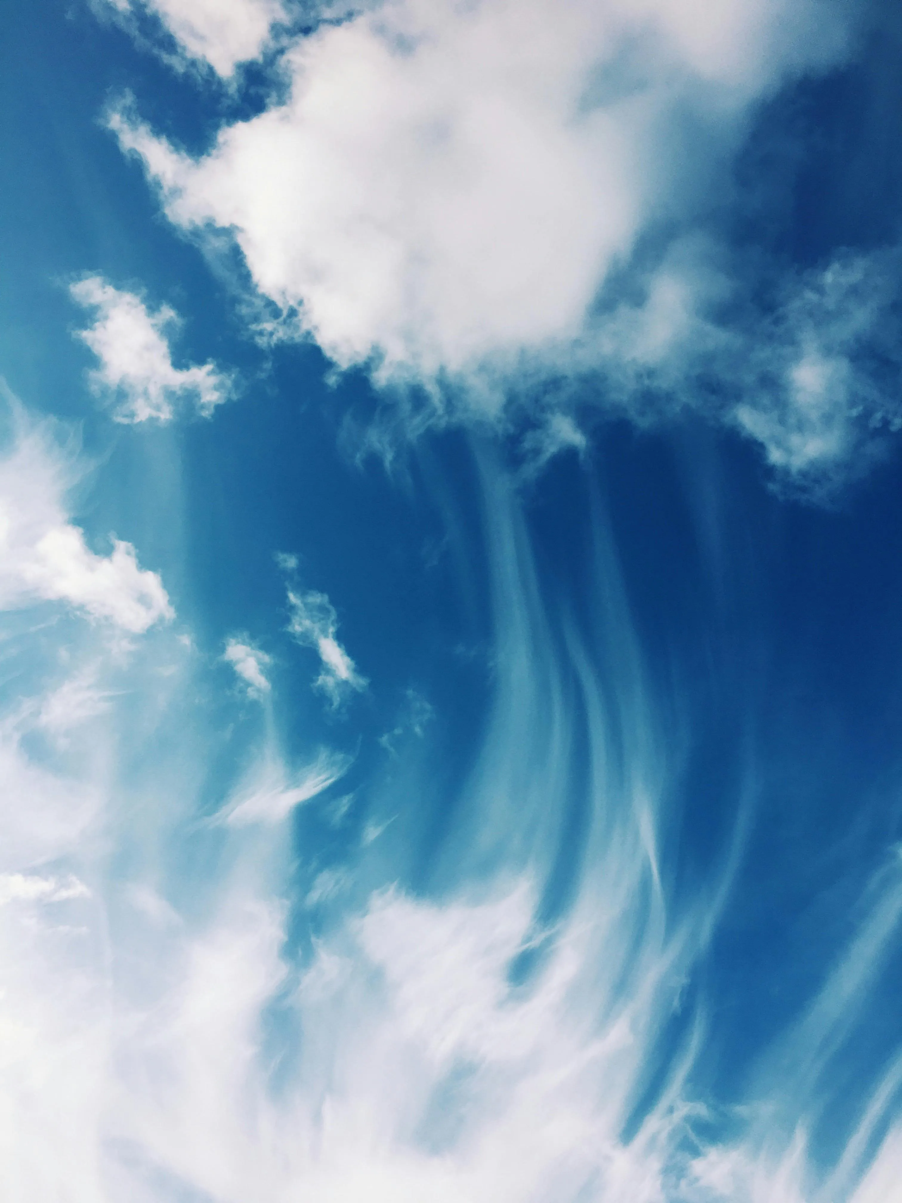 Whirling Vertical Clouds in Bright Blue Skies HD Image