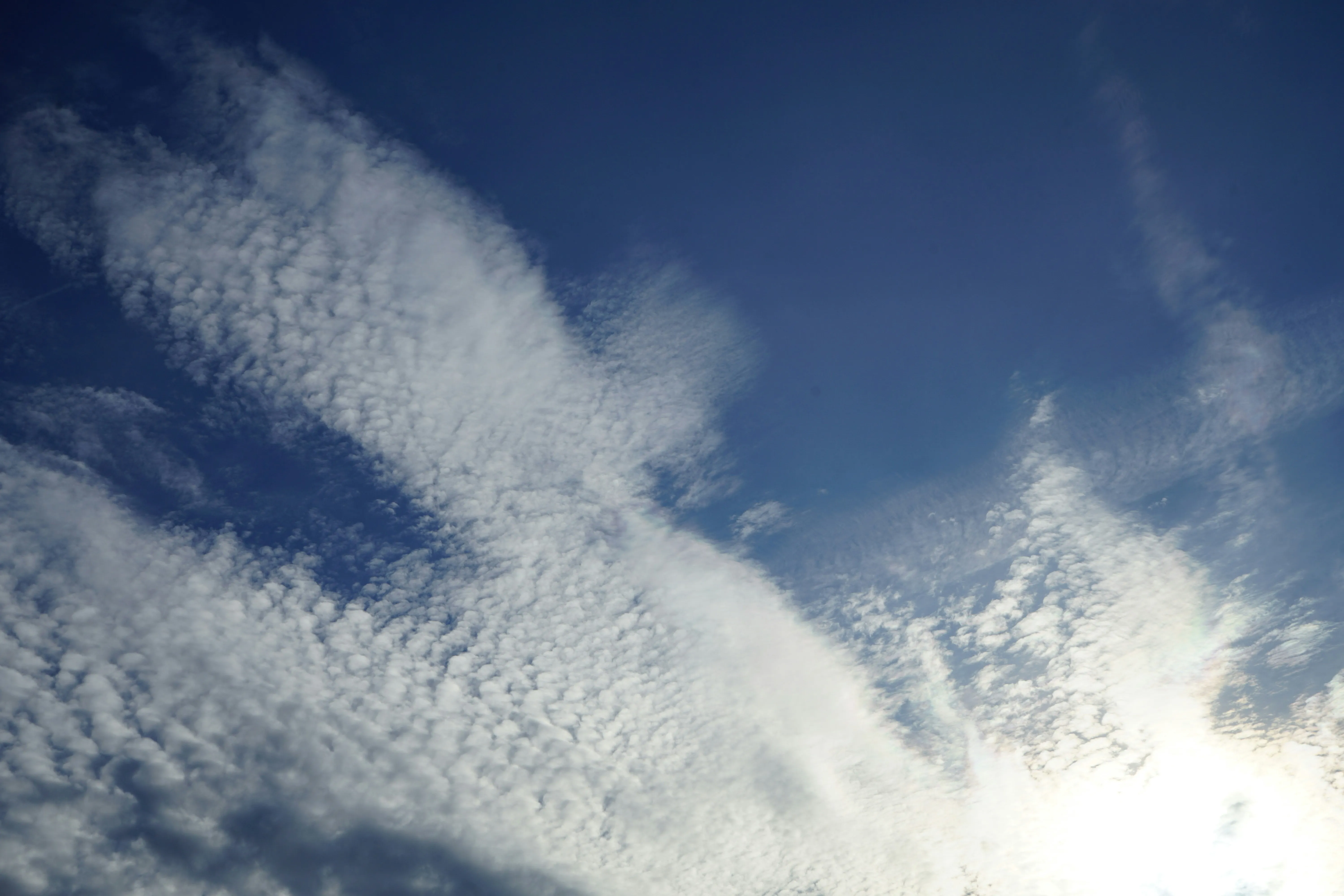 Whispy Clouds Stretched Across Deep Blue Sky Wallpaper