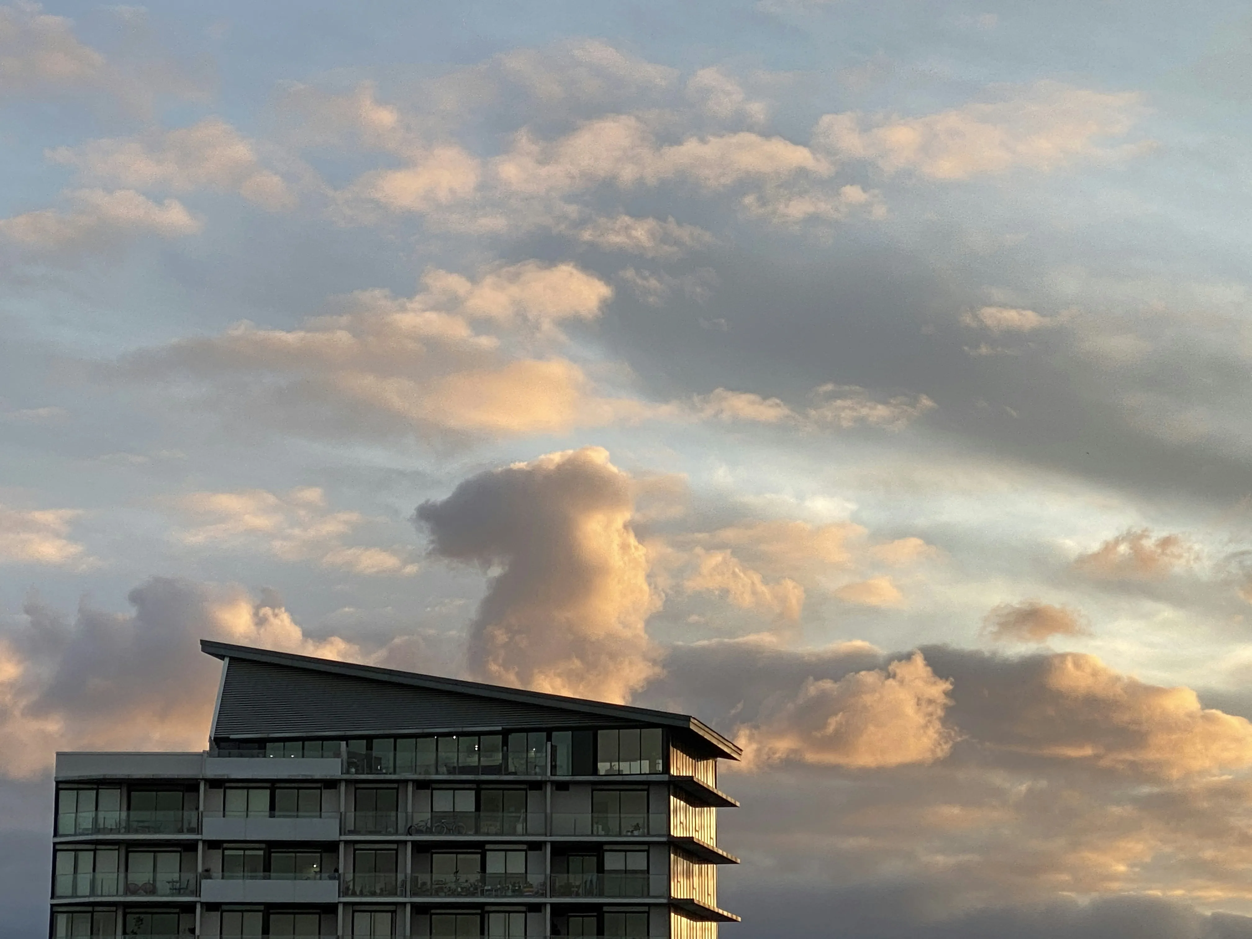 White Cloud Over Rooftop Under Bright Sunny Afternoon