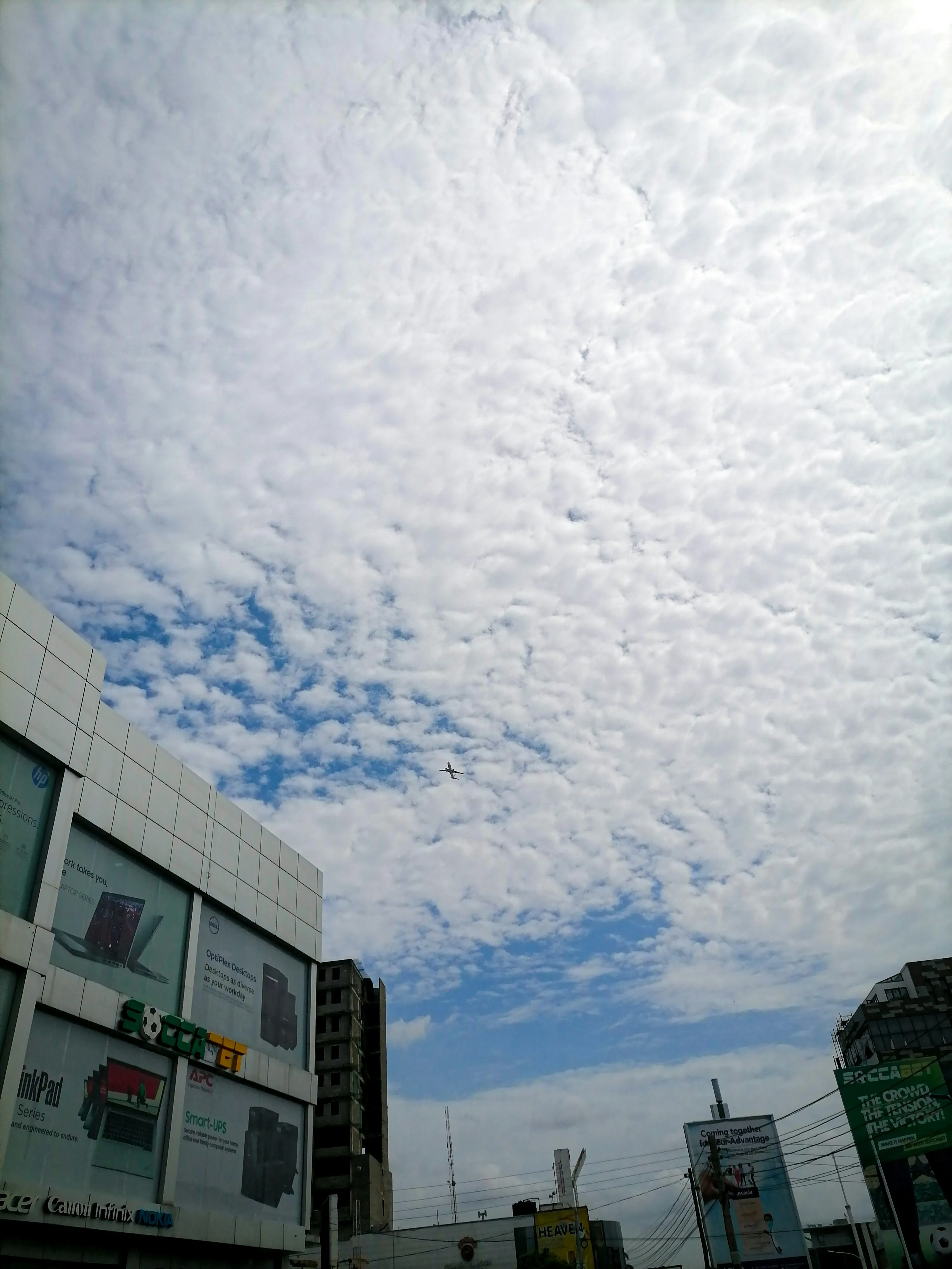 White Clouds Over City Buildings Under Clear Blue Sky