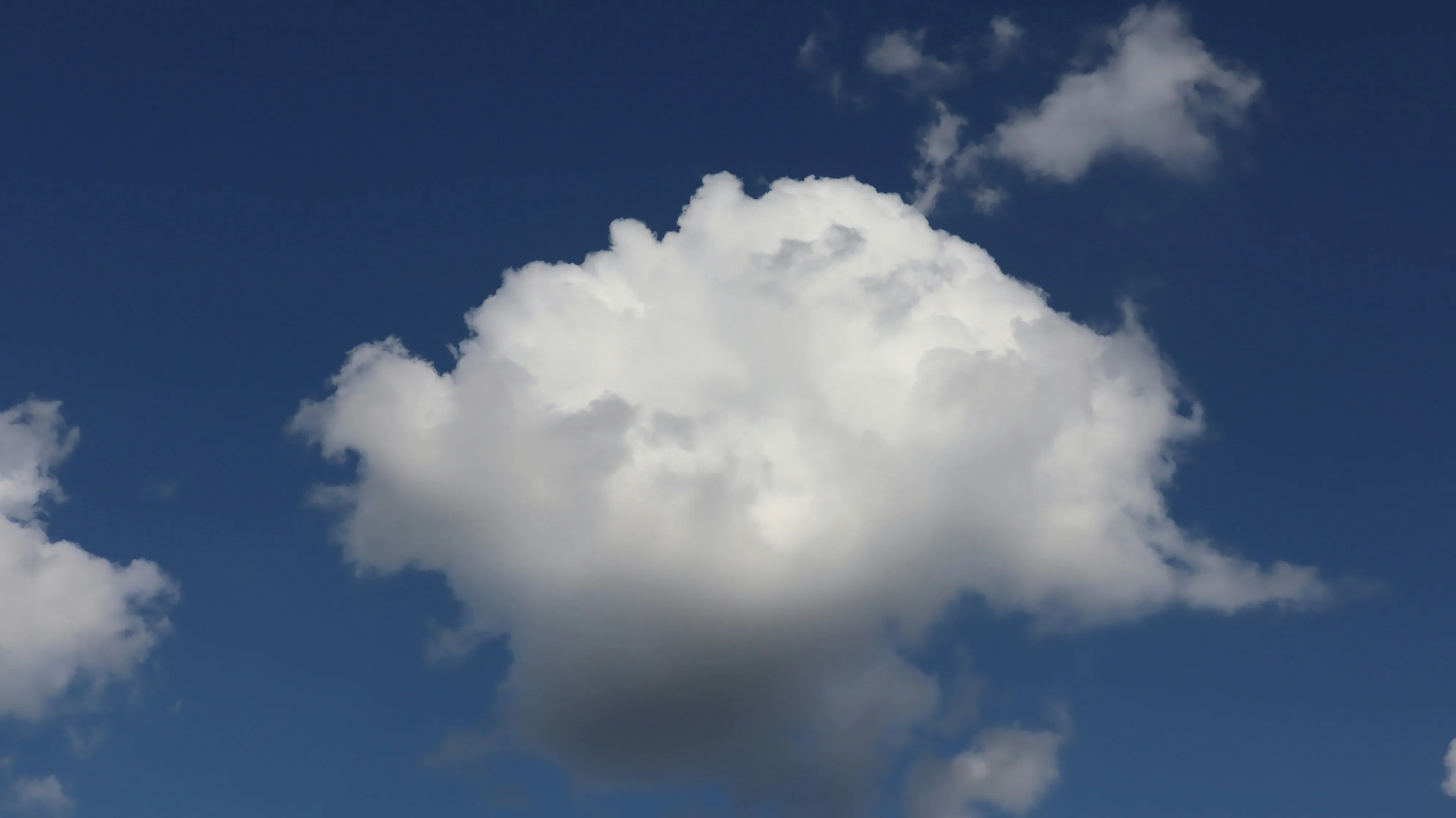 White Puffy Cloud Floating in Clear Blue Sky Wallpaper