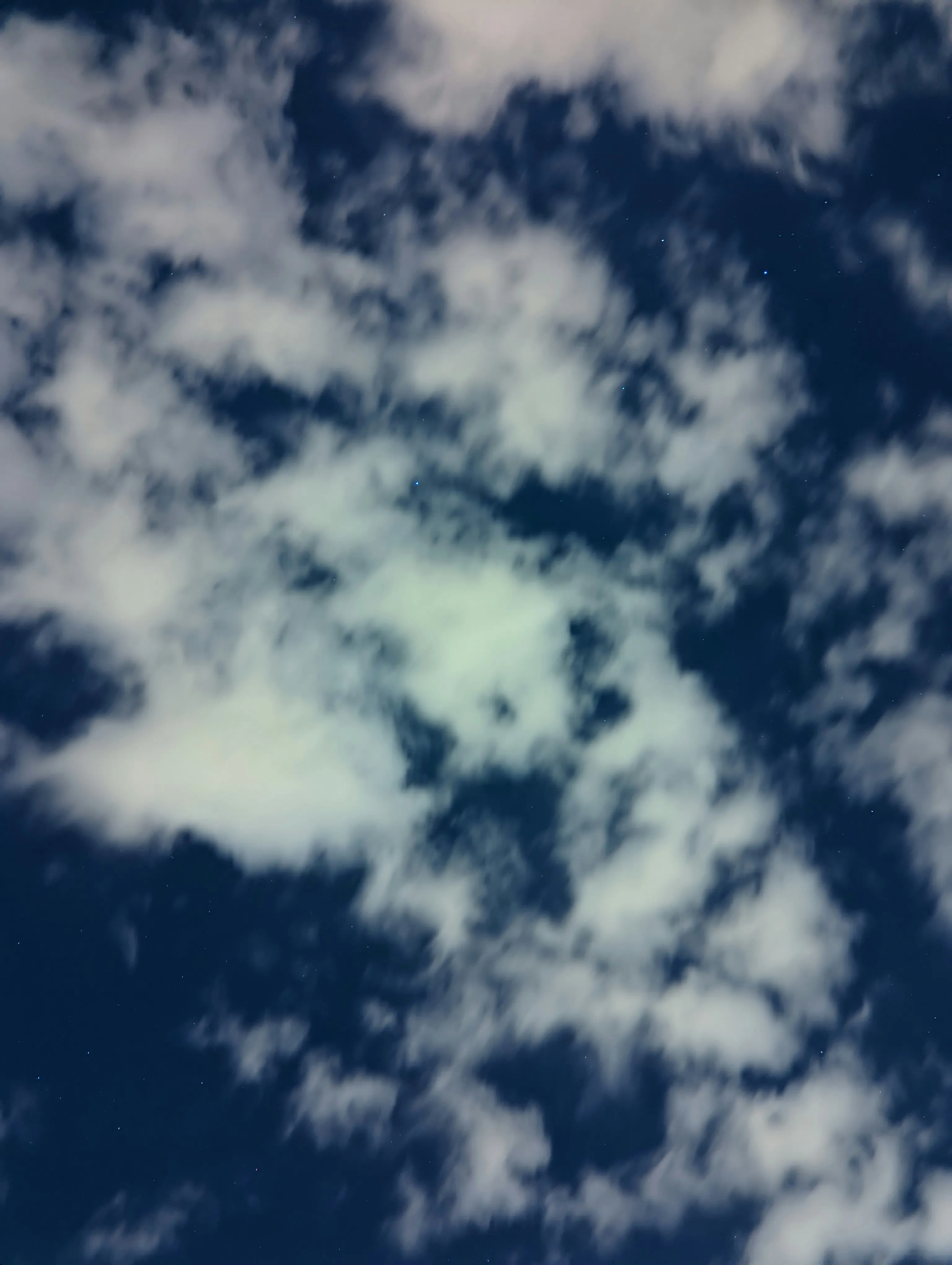 White Puffy Clouds Clustered Together Over Blue Sky