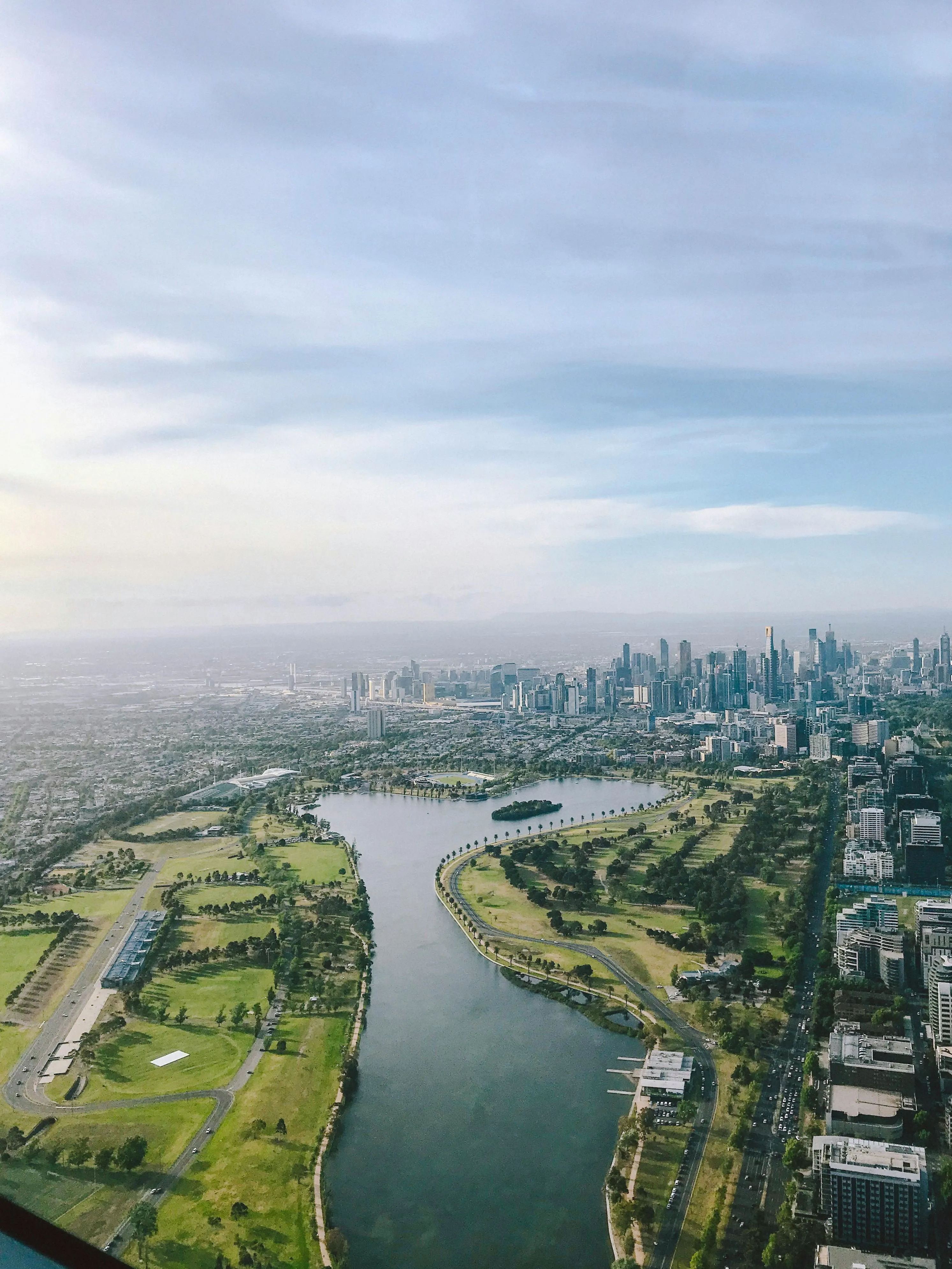 Wide Aerial View of River with Cloudy Sky Above Wallpaper