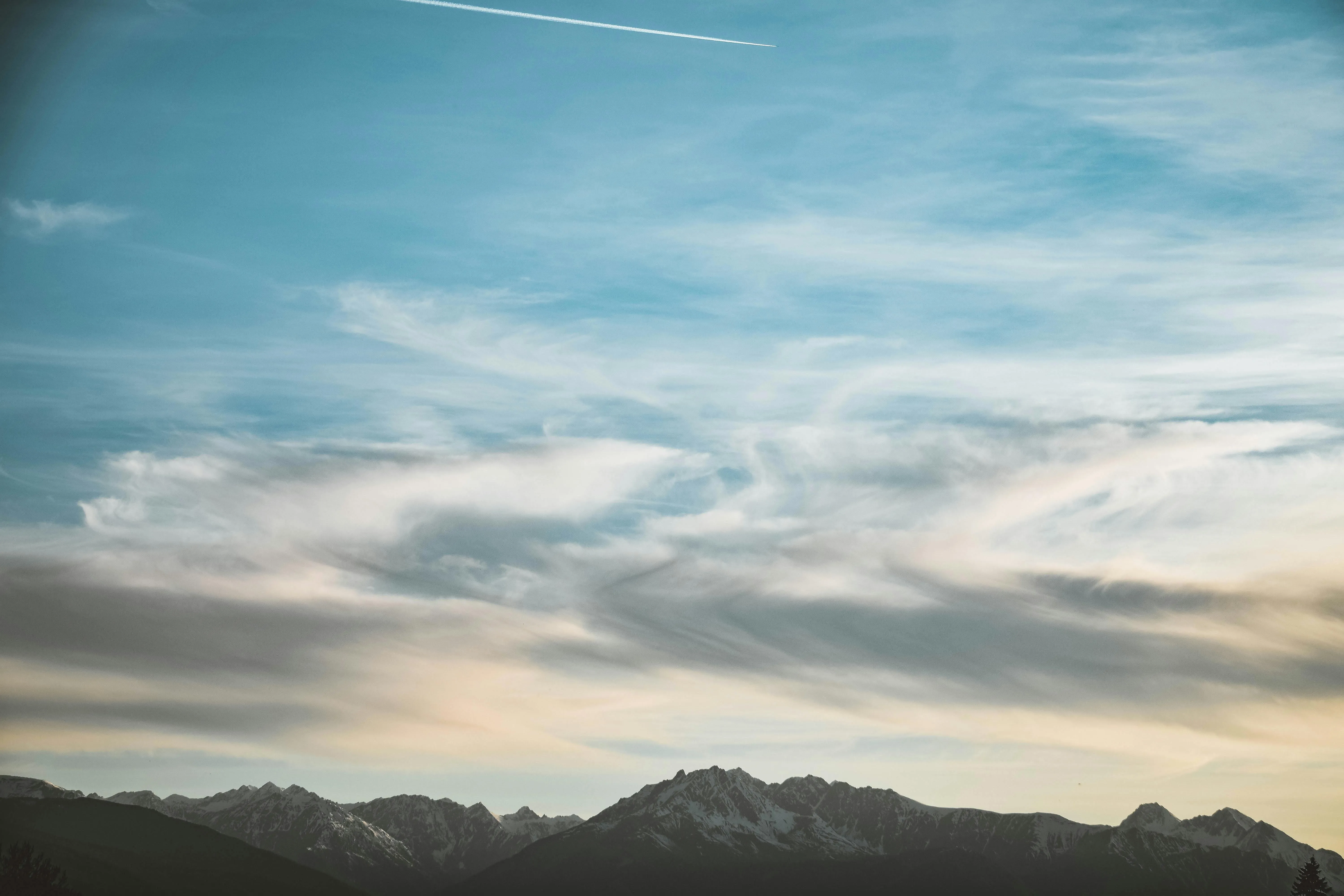 Wide View of Blue Sky with Wispy White Clouds Above